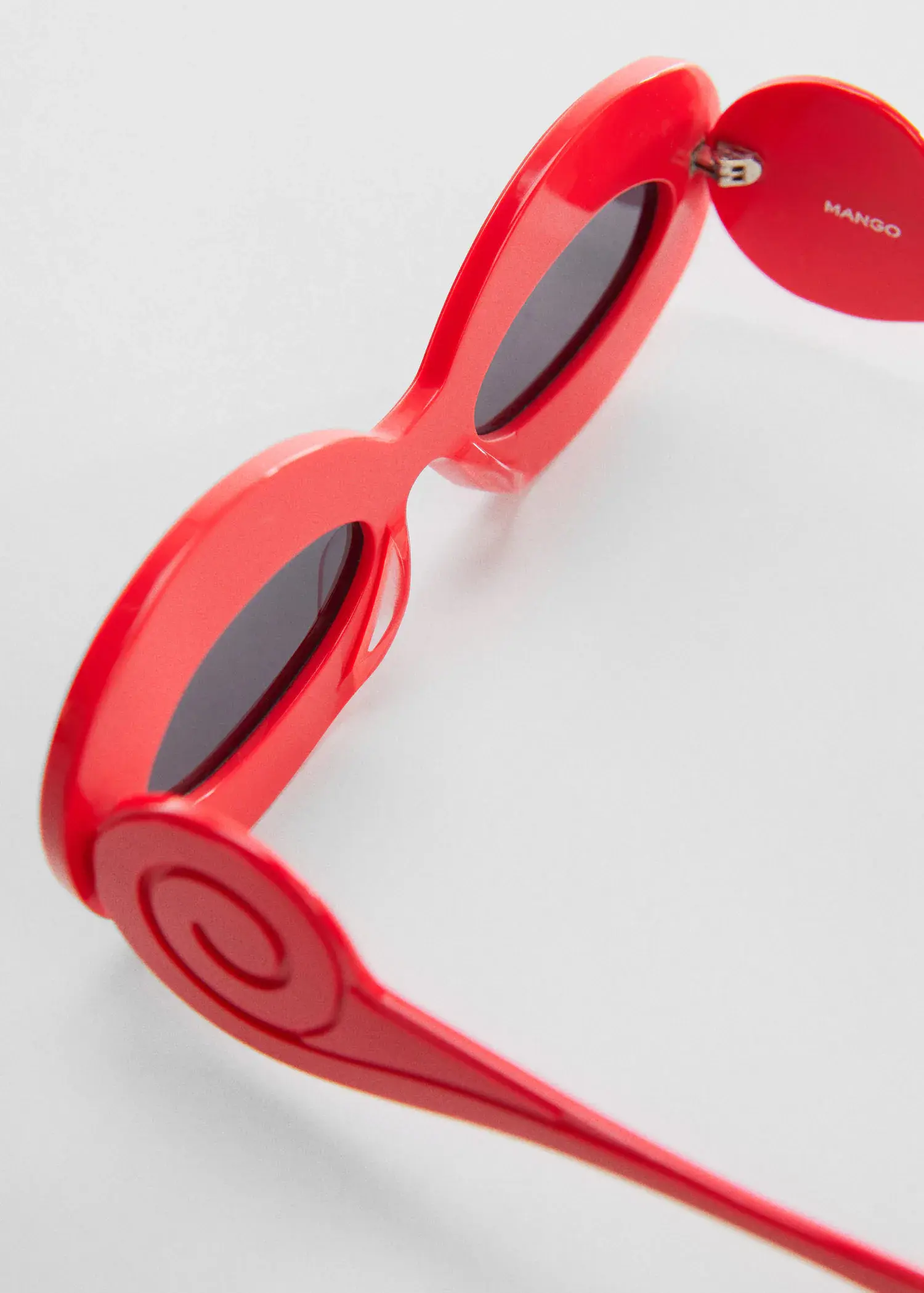 Mango Maxi-frame sunglasses. a pair of red sunglasses sitting on top of a white table. 