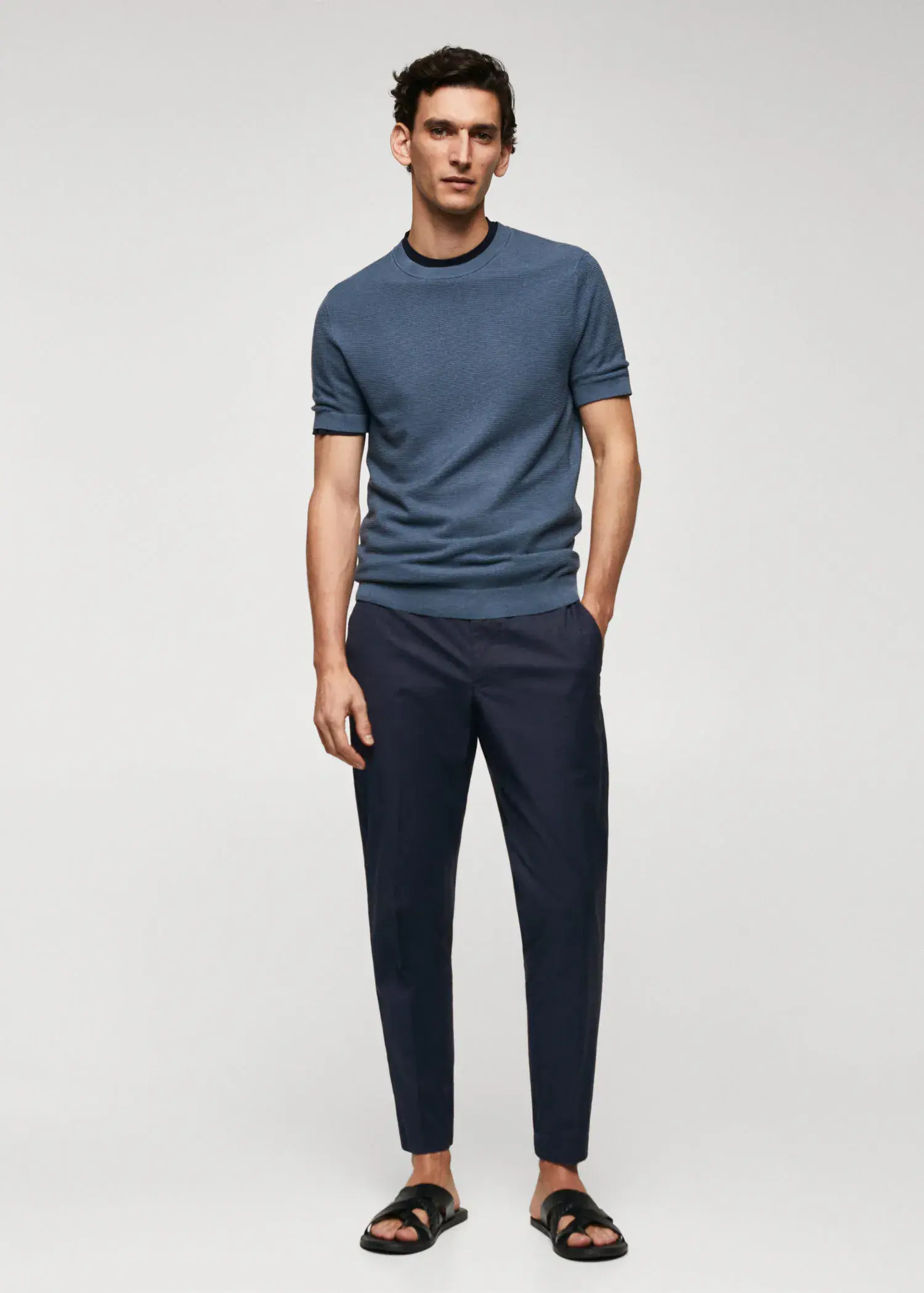 Mango Slim-fit cotton pants. a man wearing a blue shirt and black pants. 