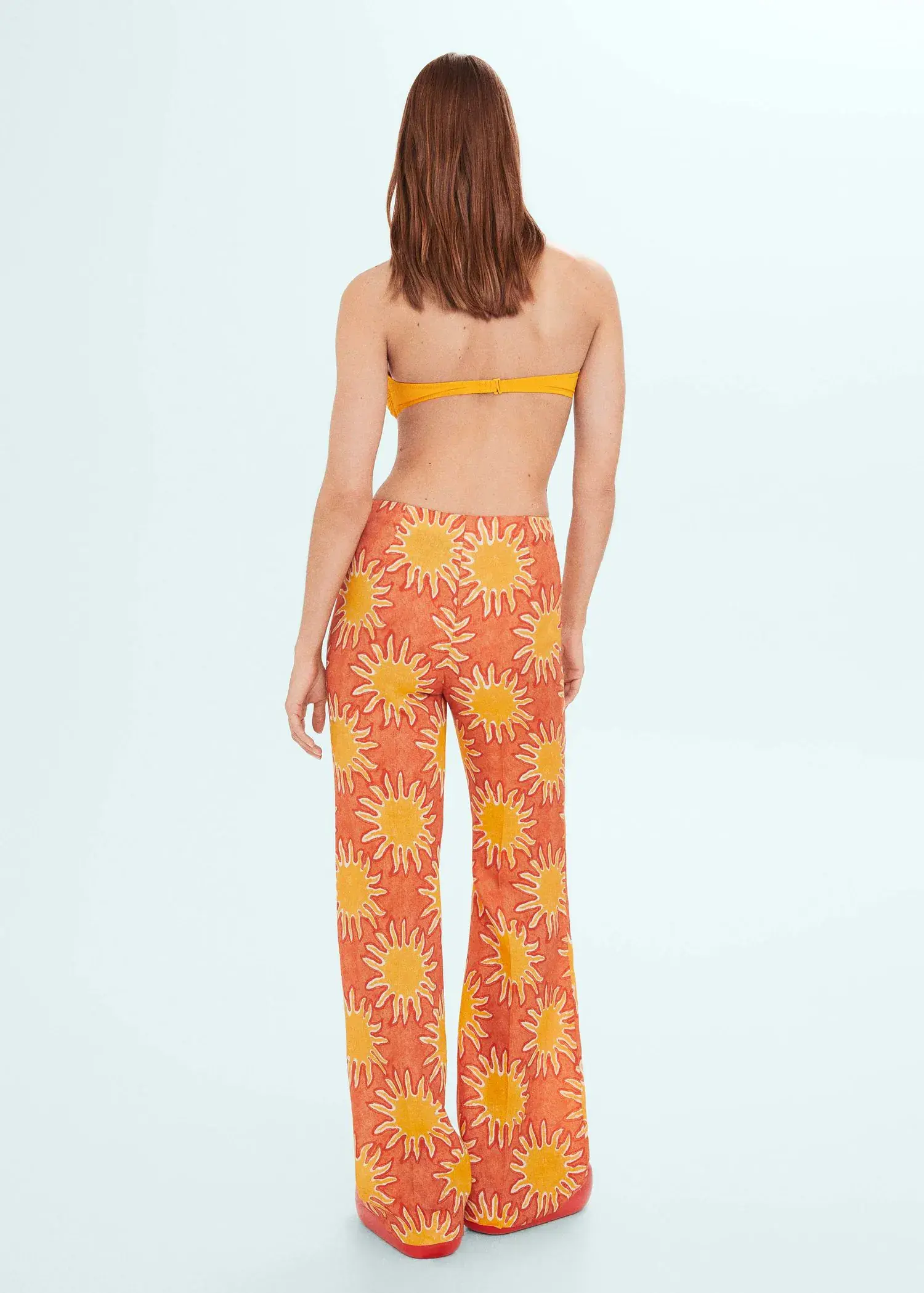 Mango Printed linen wideleg pants. a woman wearing a bikini top and pants. 