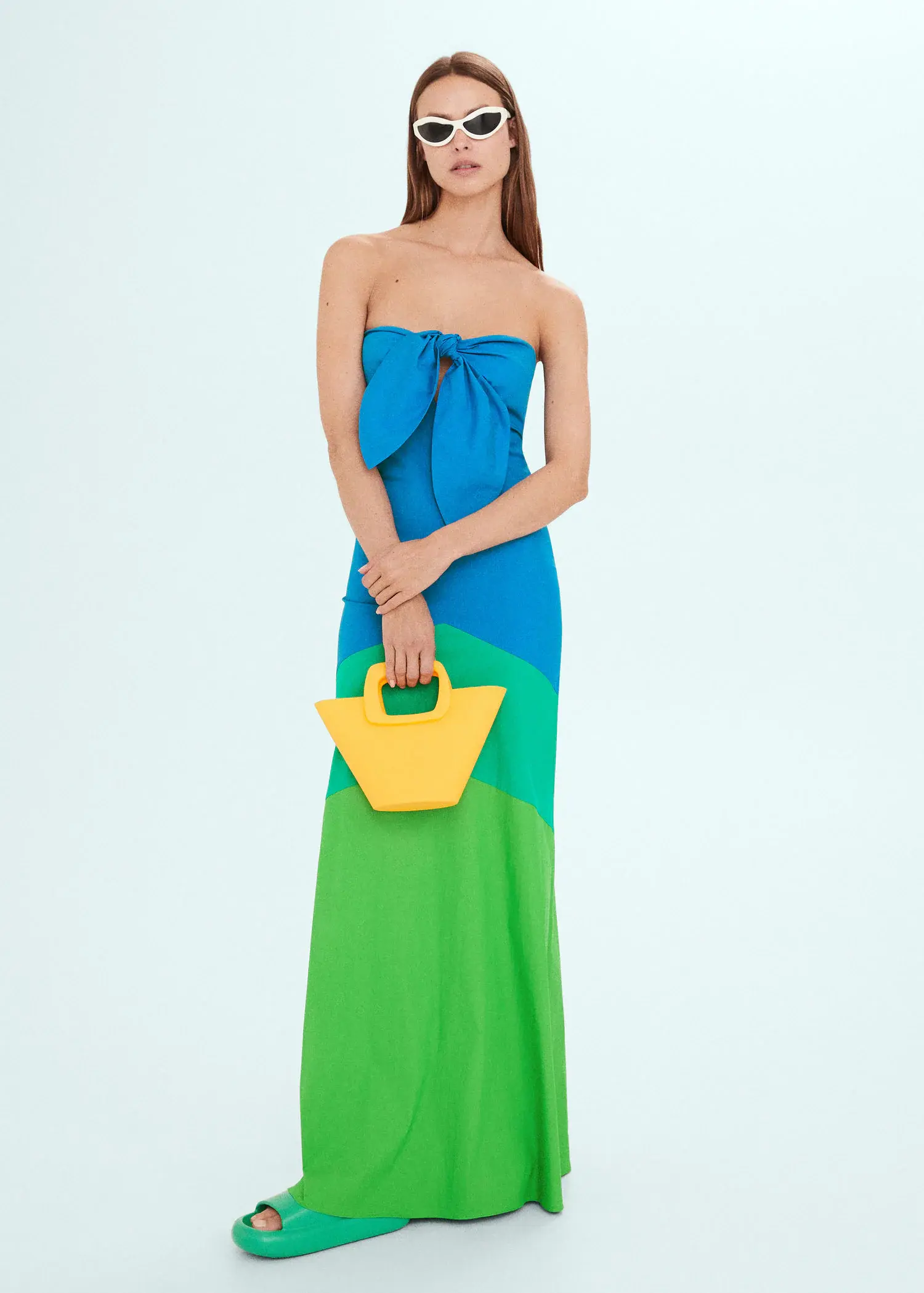Mango Multi-colored dress with knot neckline. a woman in a blue and green dress holding a yellow purse. 