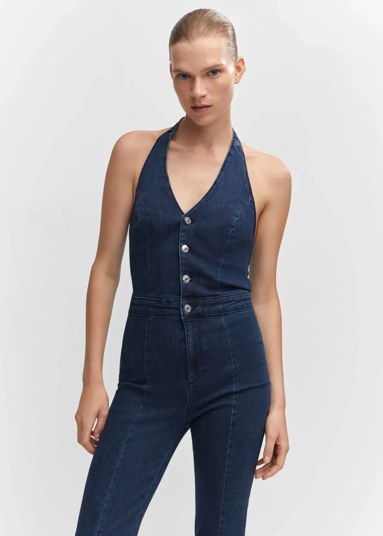 Mango Denim halter-neck jumpsuit. a woman in a blue jumpsuit is posing for a picture. 