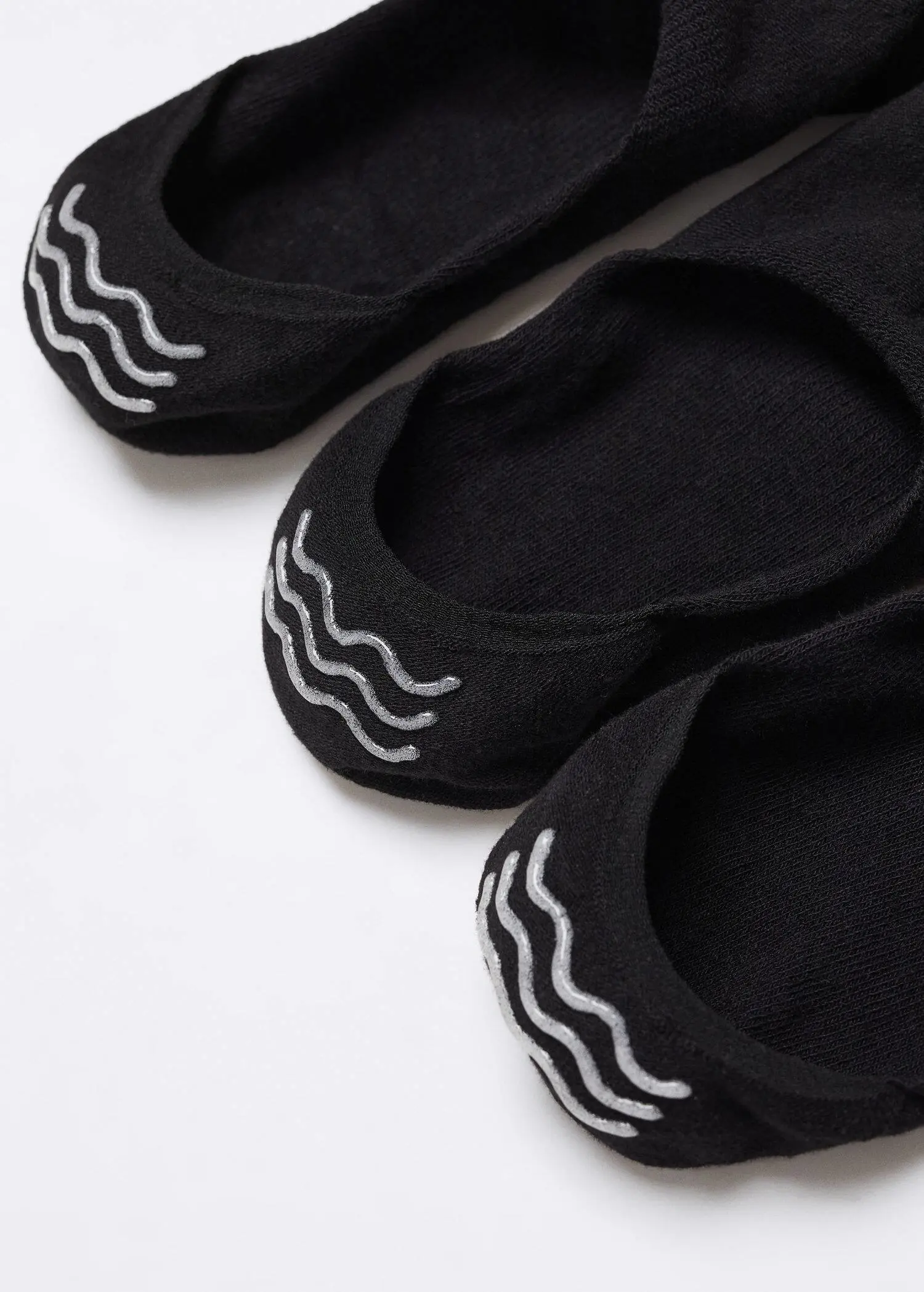 Mango 3-pack of invisible socks. three pairs of black shoes on top of a white surface. 