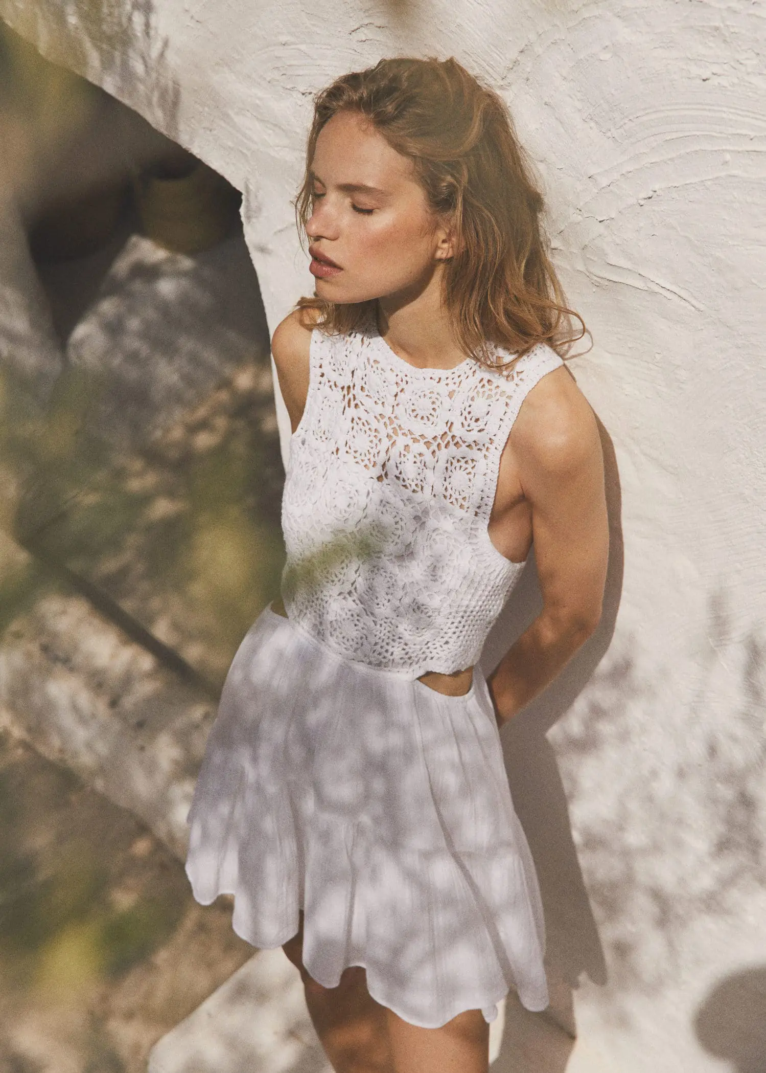 Mango Crochet dress with openings. a beautiful young lady wearing a white dress. 
