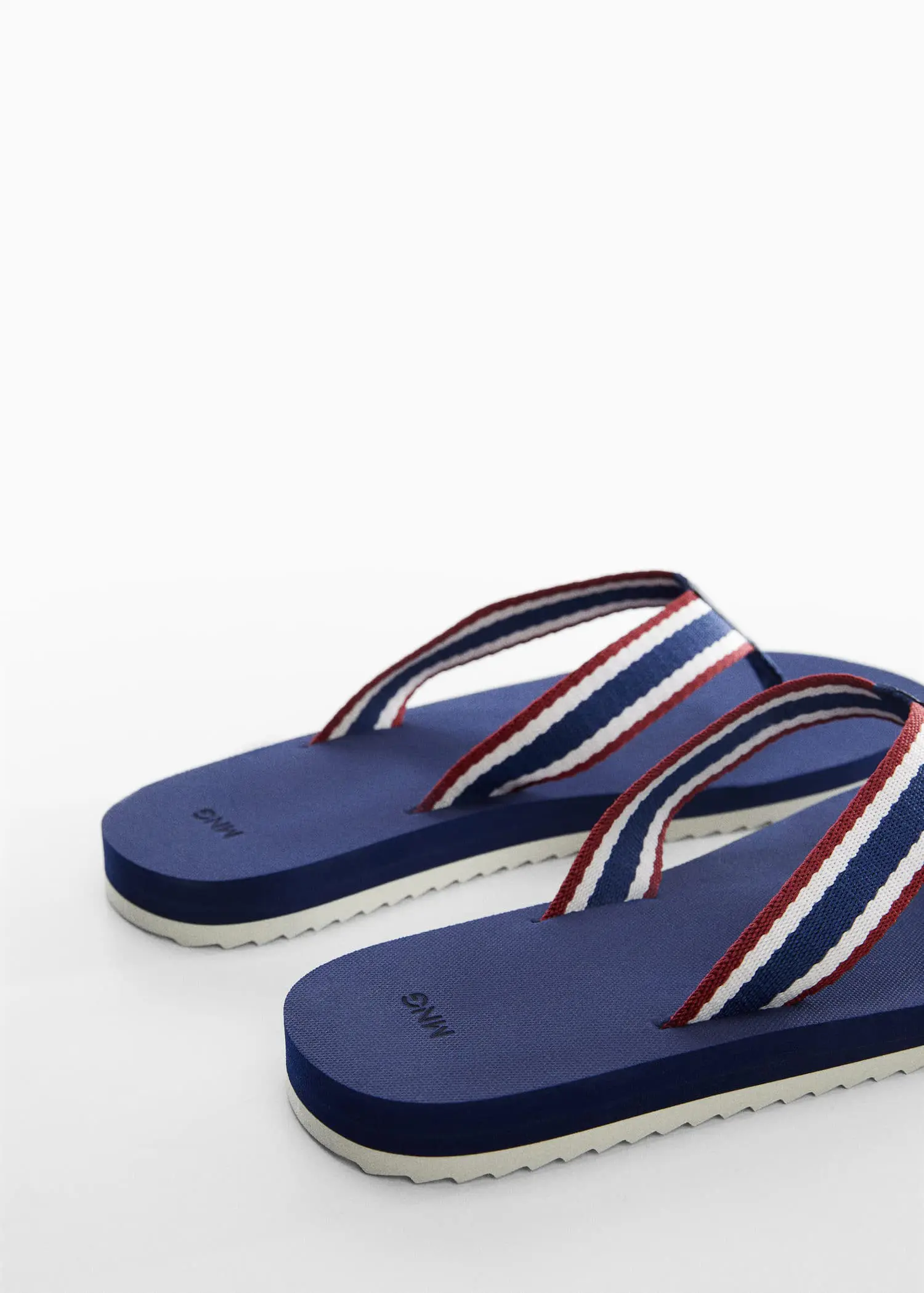 Mango Flip-flops with contrasting colour straps. a close up of a pair of flip flops. 
