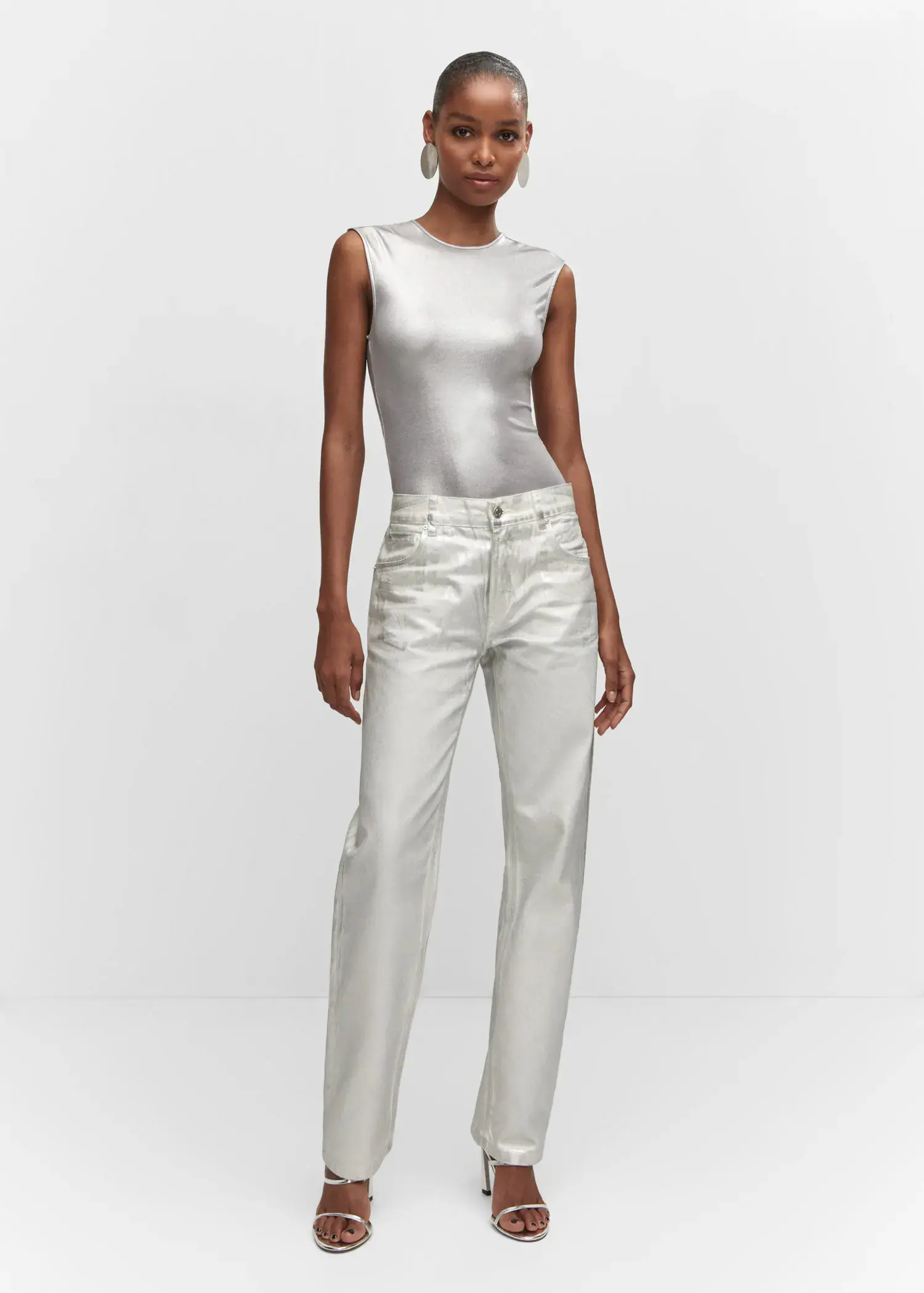 Mango Metallic straight-leg jeans. a woman in a silver top and white pants. 