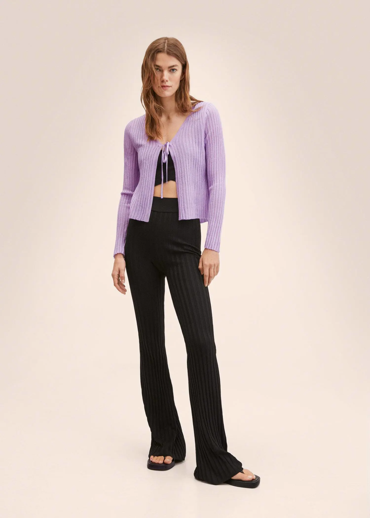Mango Knitted cropped cardigan. a woman wearing a purple cardigan and black pants. 