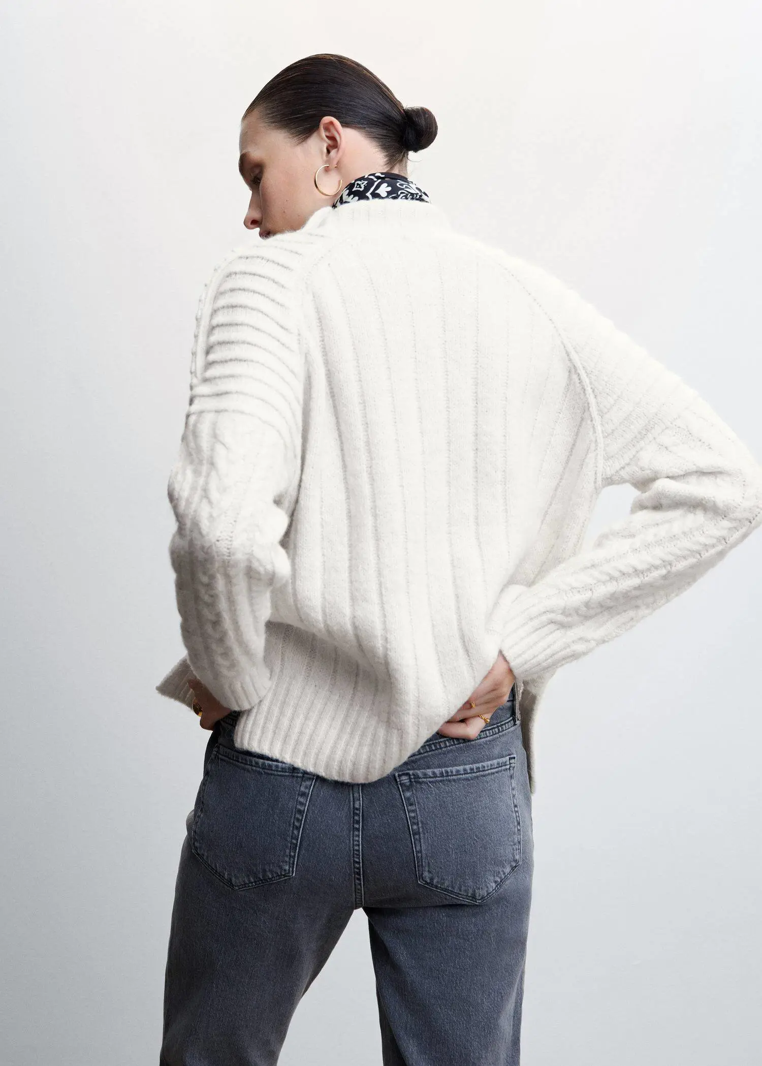 Mango Buttoned knit braided sweater. a woman wearing a white sweater and jeans. 