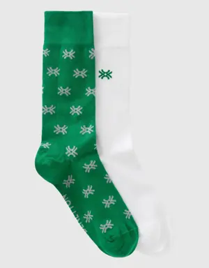 two pairs of white and dark green socks