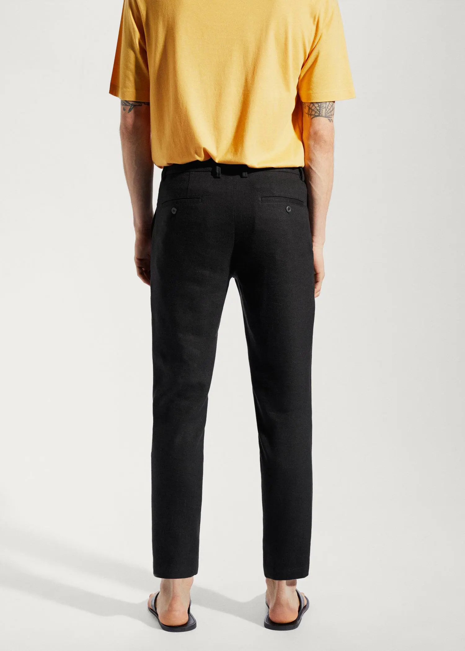 Mango Linen slim-fit trousers with inner drawstring. a person wearing a yellow shirt and black pants. 