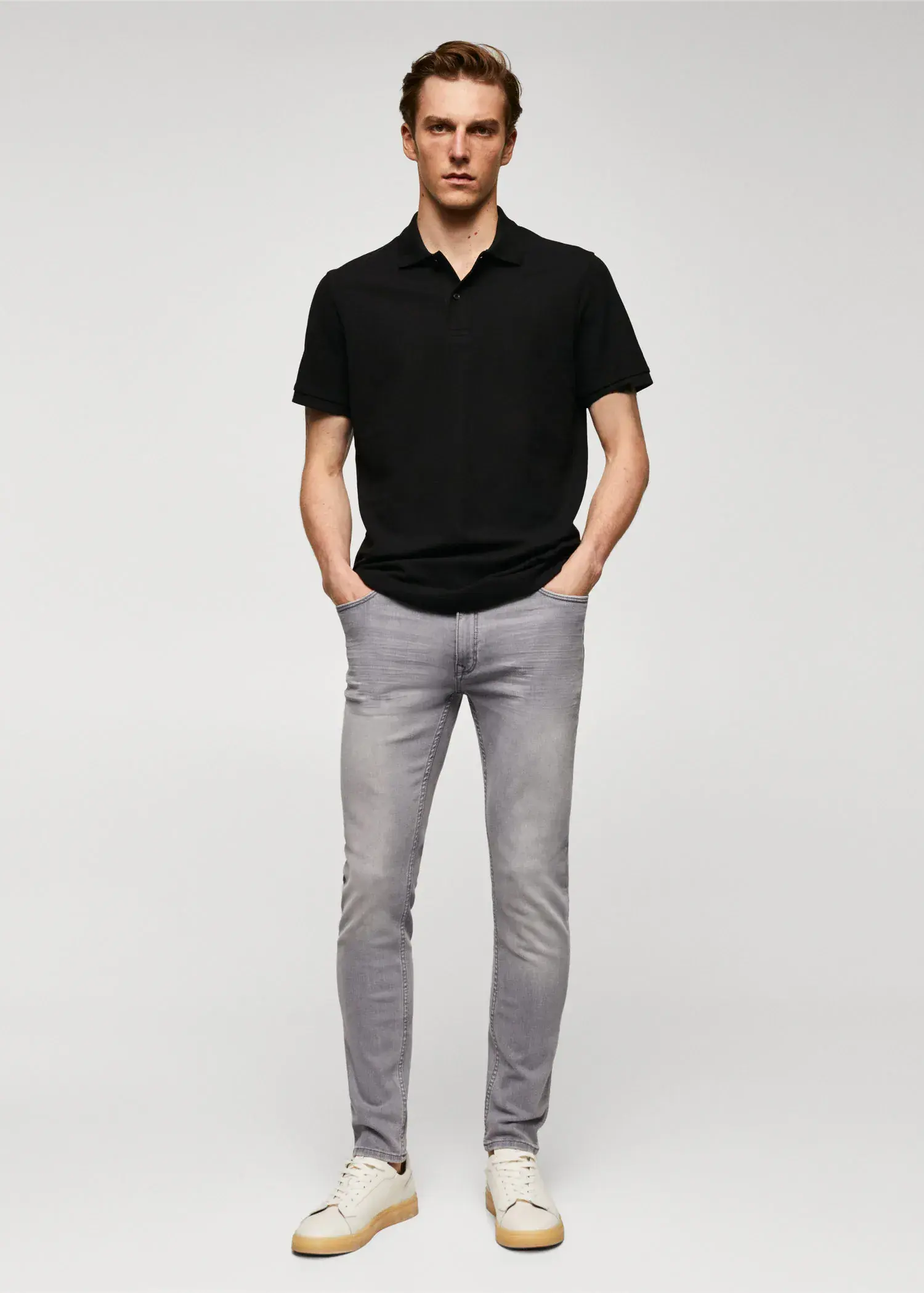 Mango Jude skinny-fit jeans. a man in a black shirt and gray pants. 