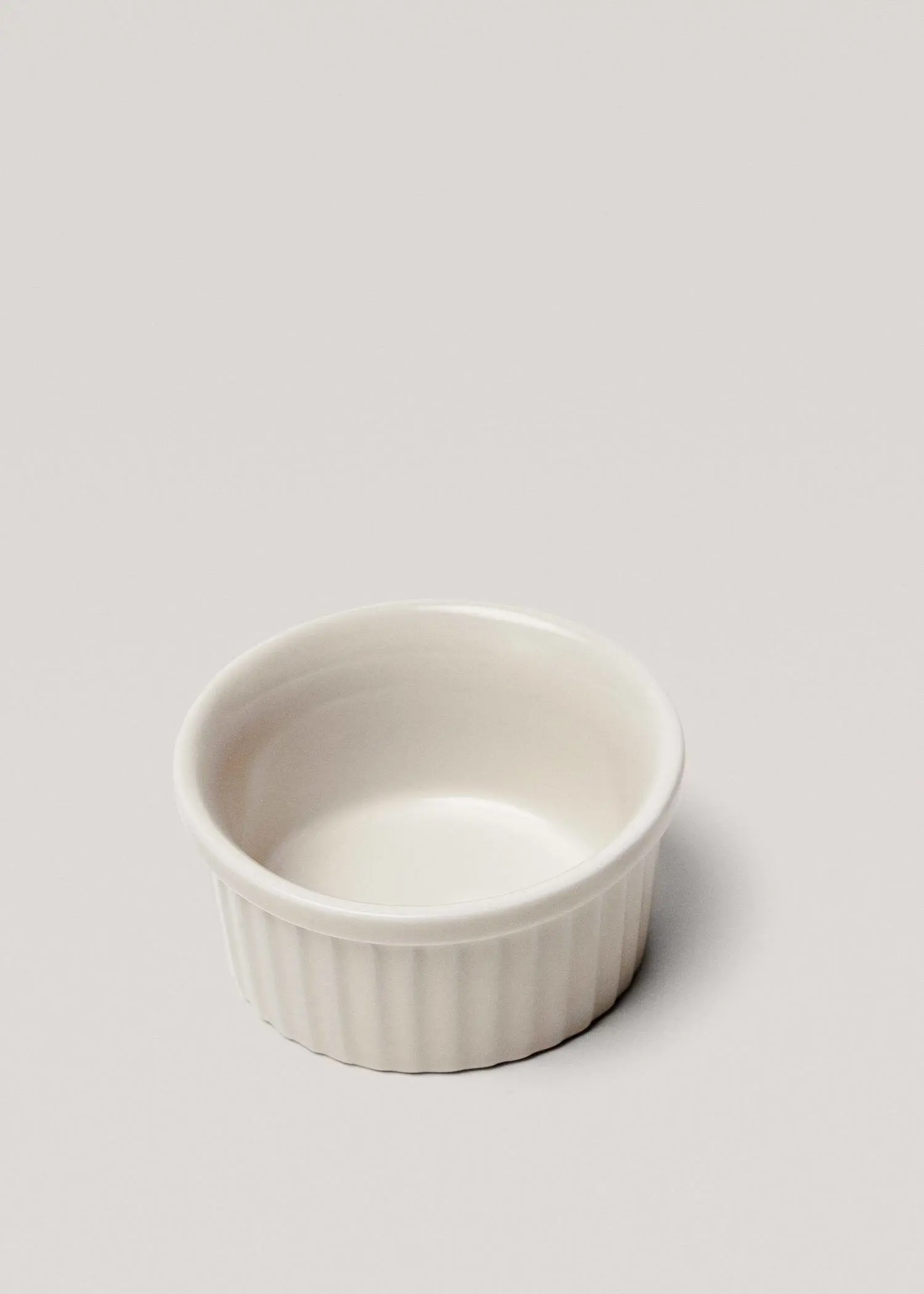 Mango Porcelain bowl 85cm. a small white bowl sitting on top of a table. 