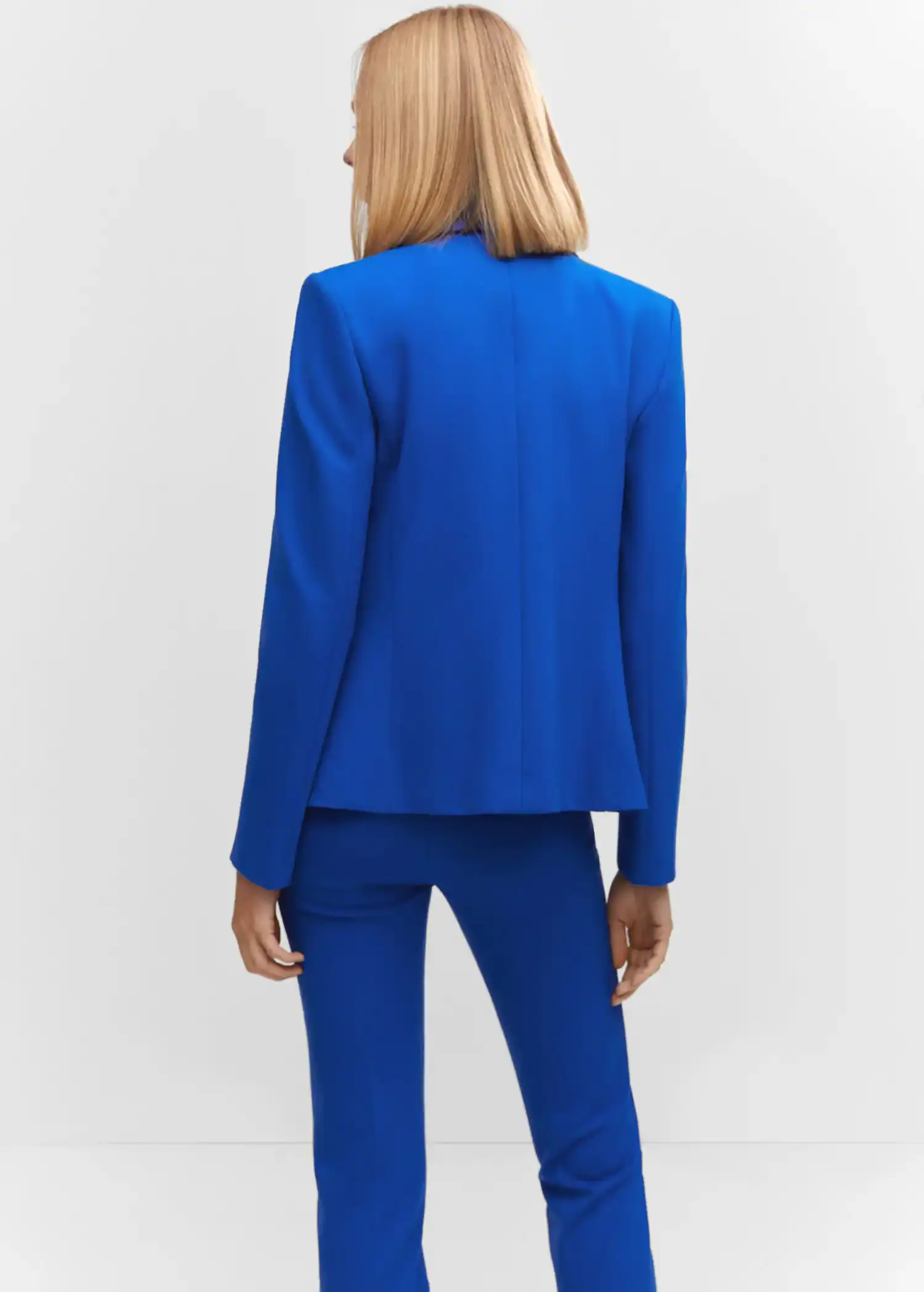 Mango Fitted blazer with blunt stitching. a woman in a blue suit is posing for a picture. 