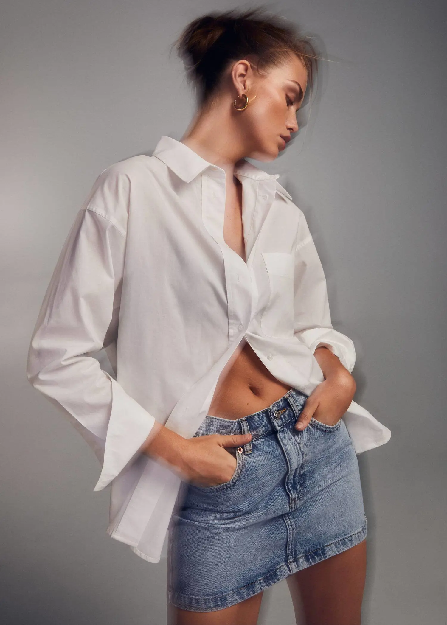 Mango Denim miniskirt. a woman wearing a white shirt and jeans. 