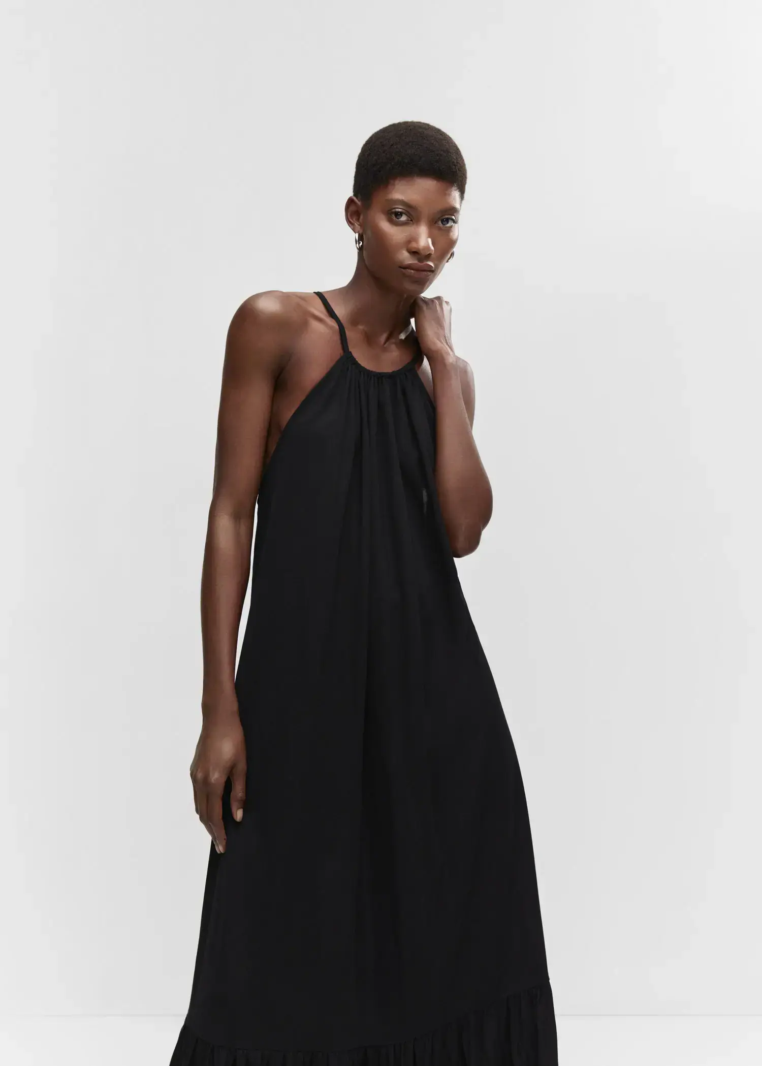 Mango Cross-back maxi-dress. a woman in a black dress posing for a picture. 