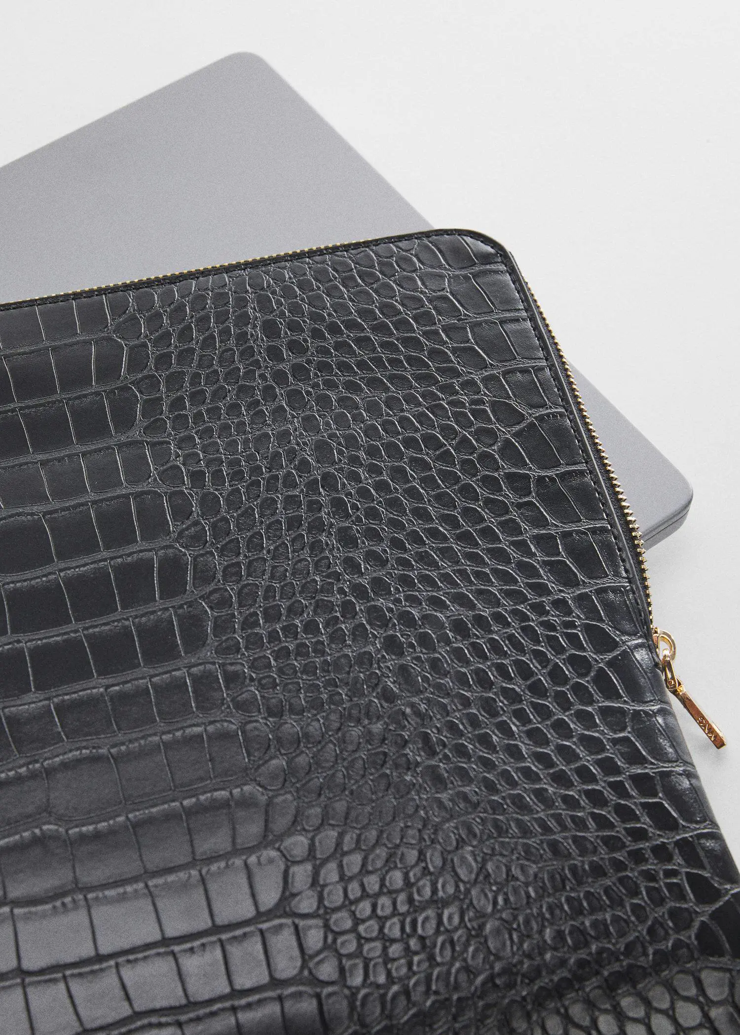 Mango Animal print laptop case. a close-up of a laptop case with a gold zipper. 