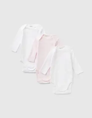 three solid color bodysuits in organic cotton