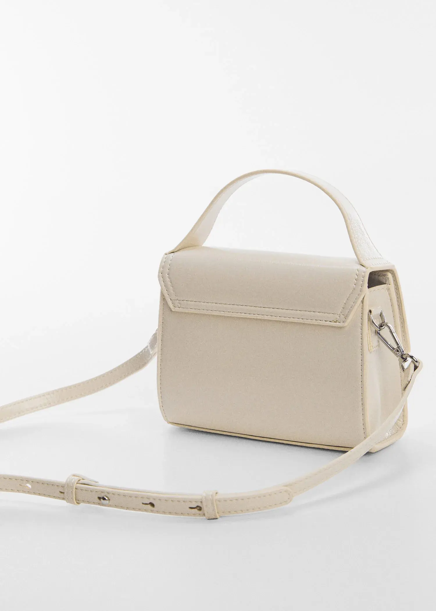 Mango Buckled flap bag. a white purse sitting on top of a white table. 