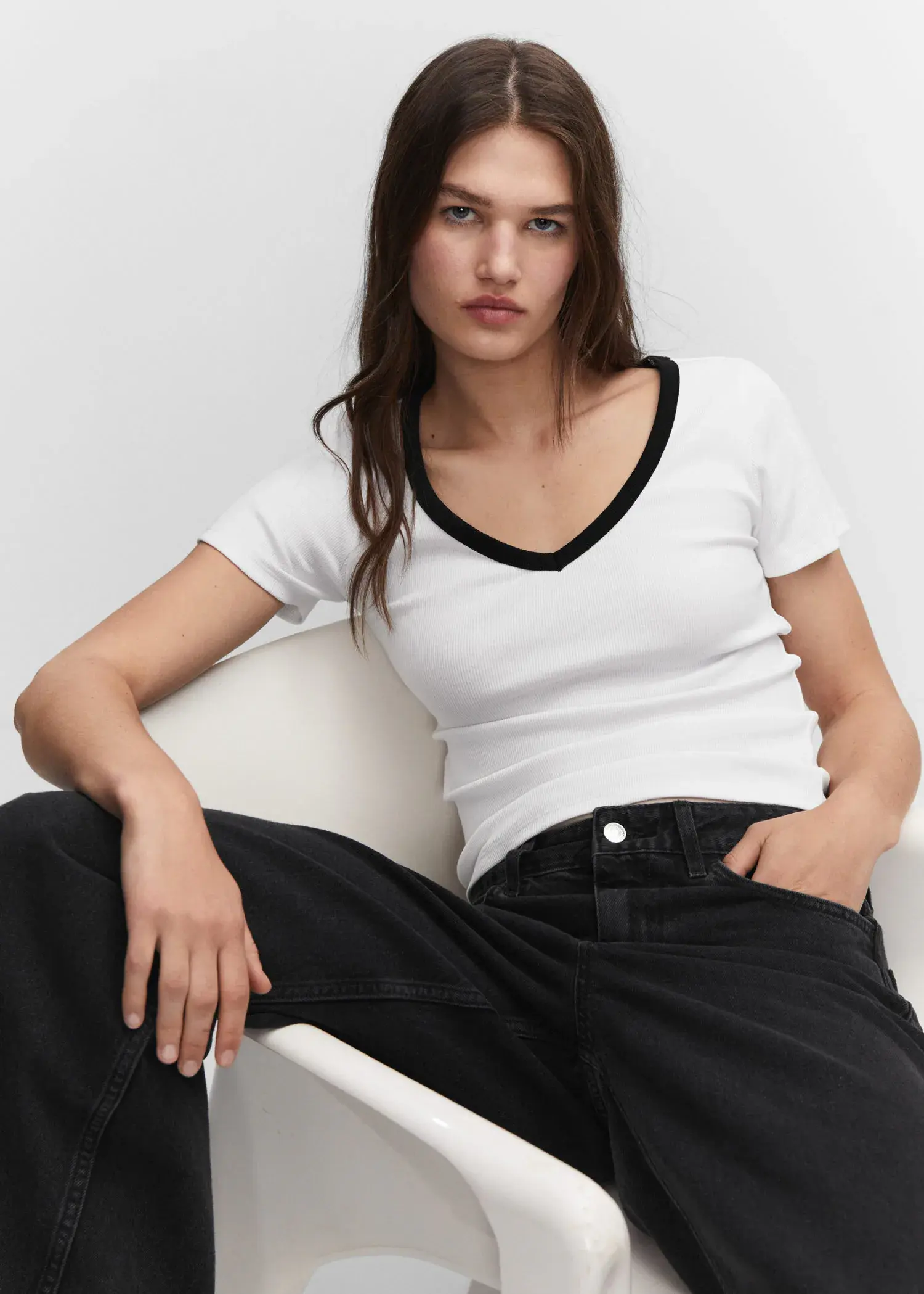 Mango Contrast collar shirt. a woman sitting on top of a white chair wearing black jeans. 