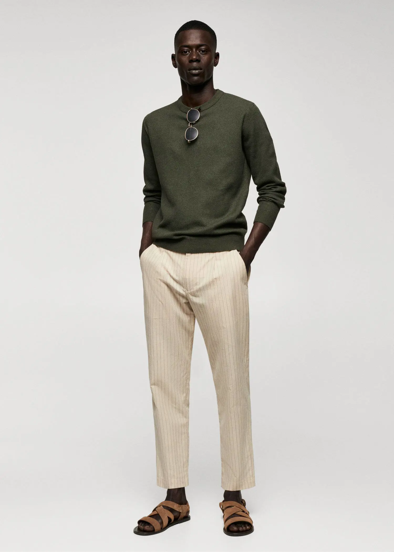 Mango Structured cotton sweater. a man in a green sweater and beige pants. 