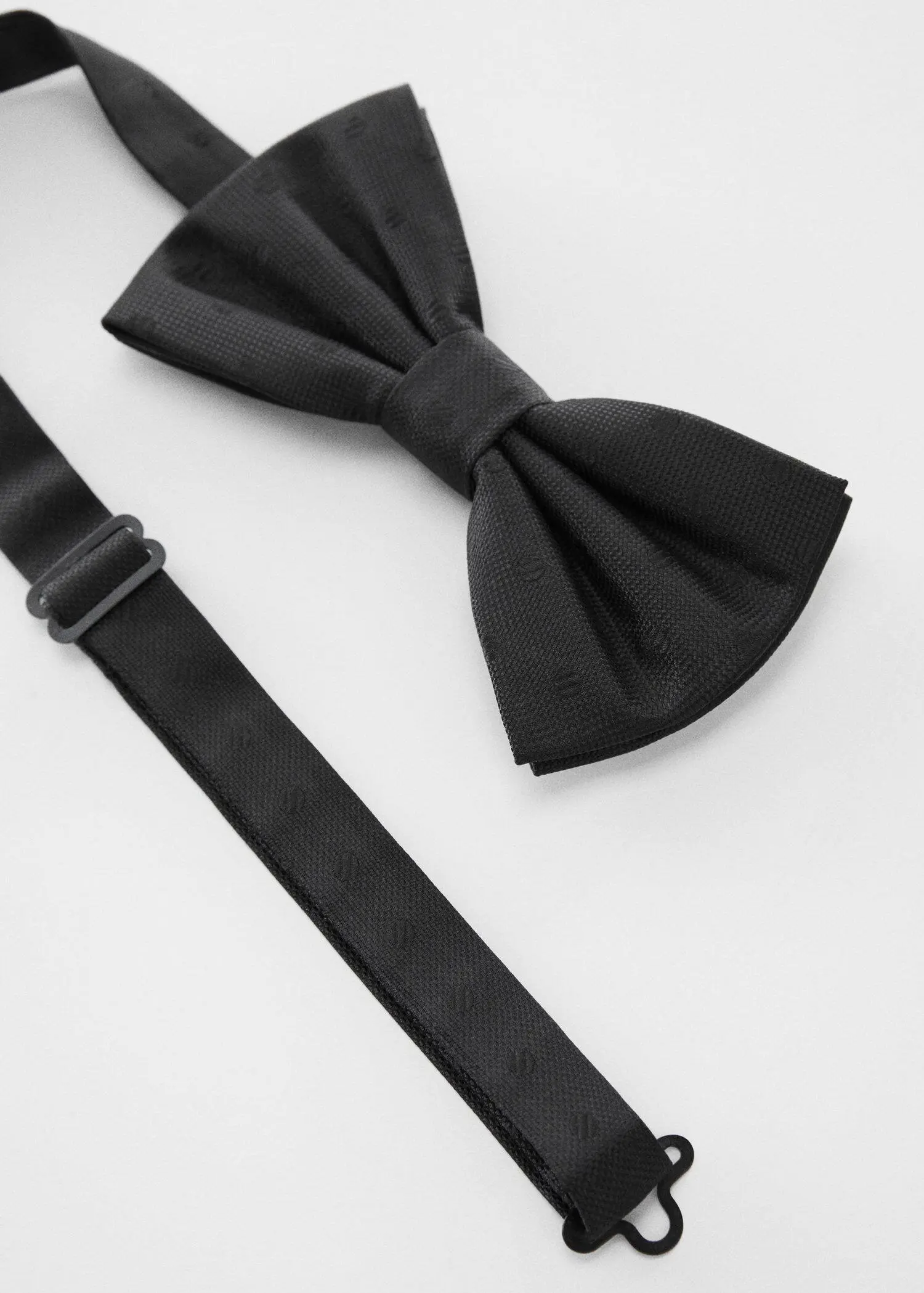 Mango Bow tie with polka-dot structure. a black bow tie next to a black suspenders. 