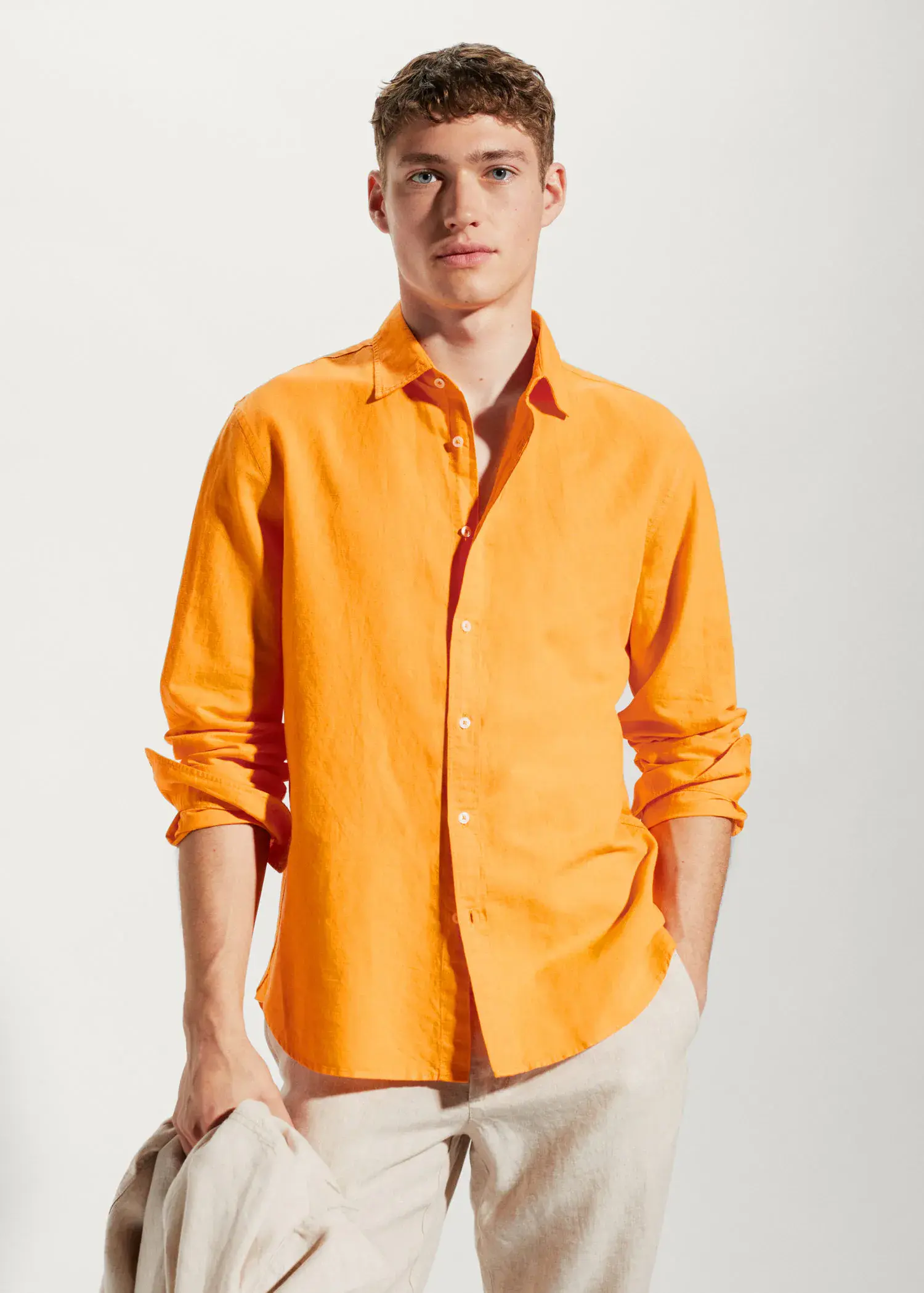 Mango Regular-fit linen cotton shirt. a man in a yellow shirt is posing for a picture 