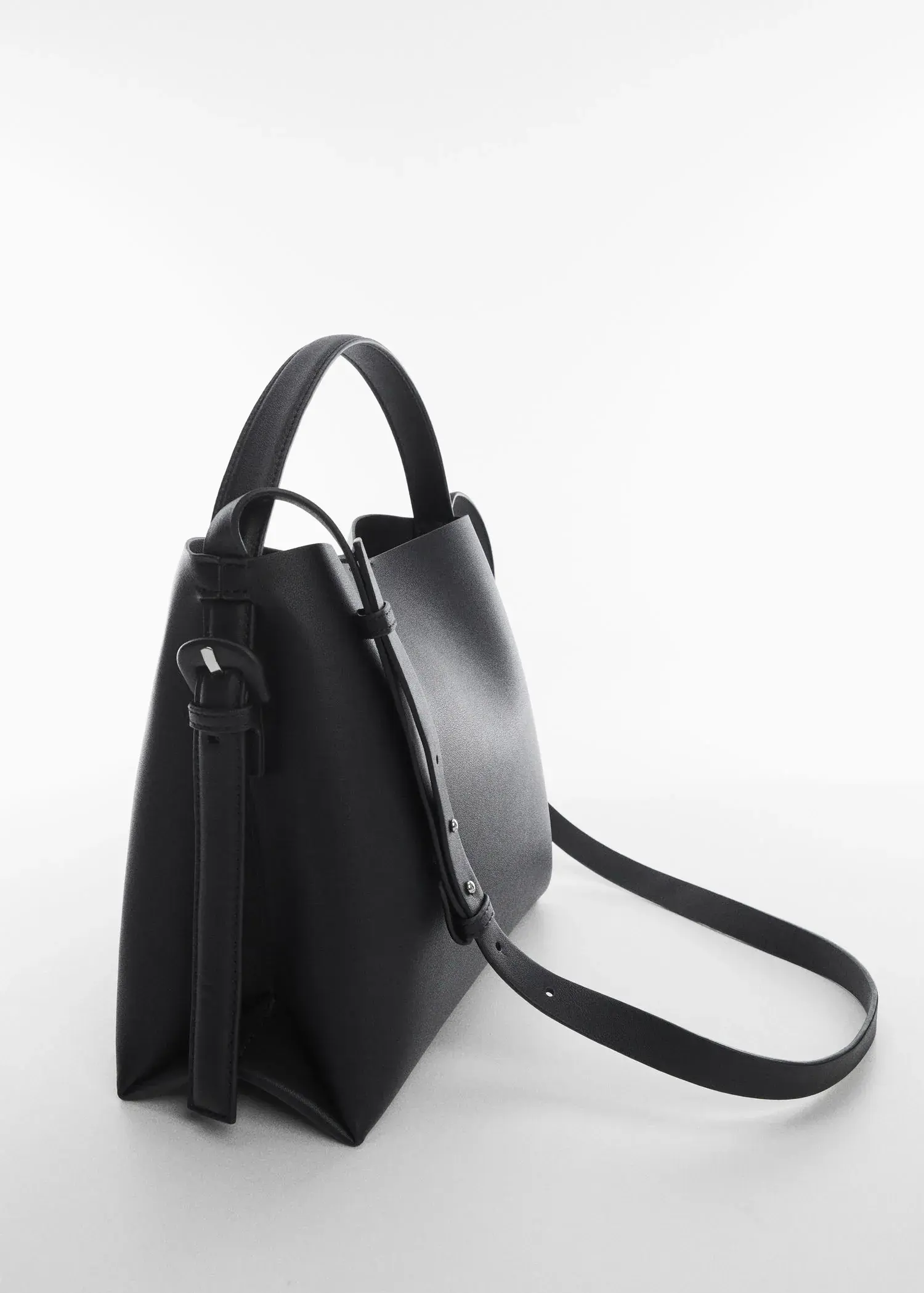 Mango Shopper bag with buckle. a close up of a black purse on a white surface 