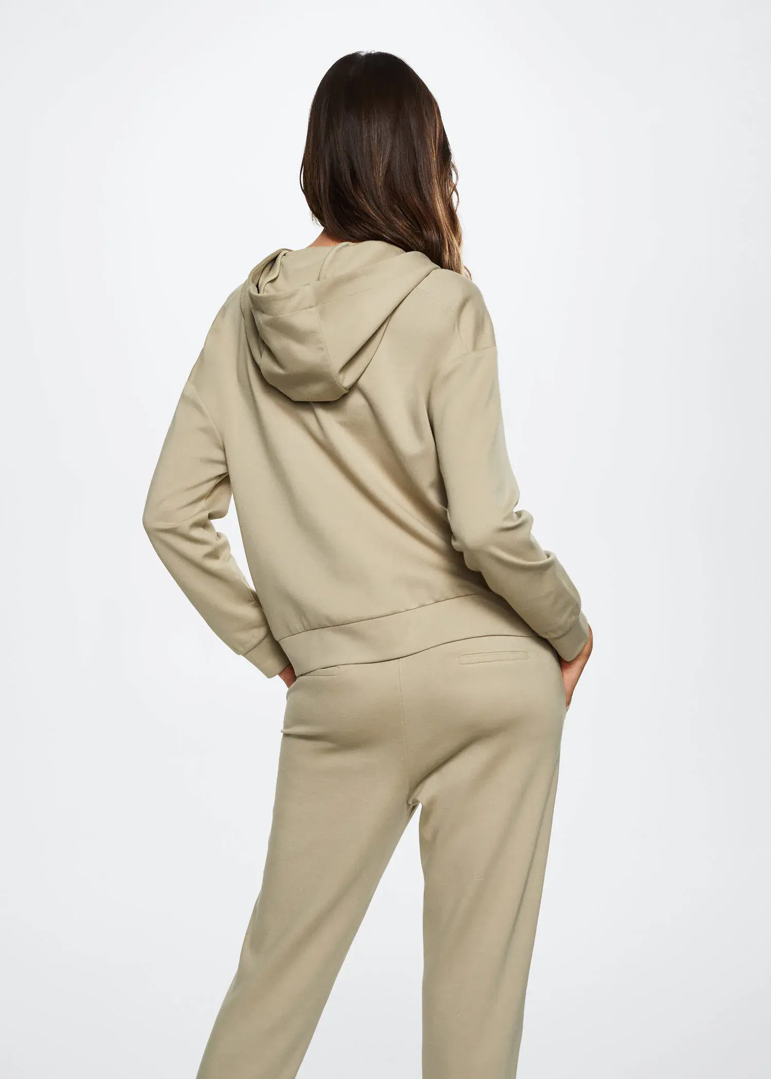 Mango Zipper high collar sweater. a woman in a tan outfit is standing with her hands in her pockets. 