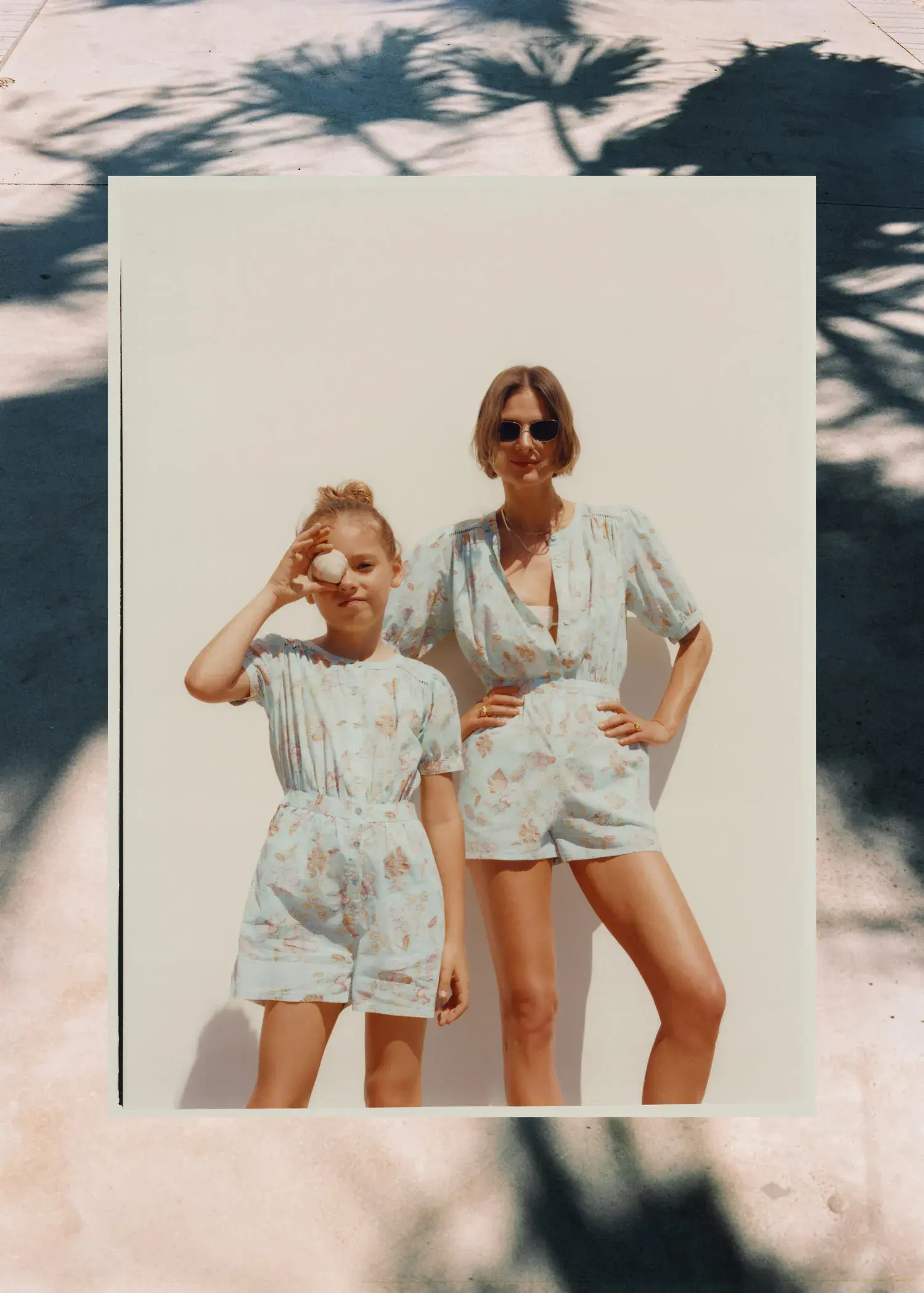 Mango Printed short jumpsuit. a woman standing next to a young girl. 