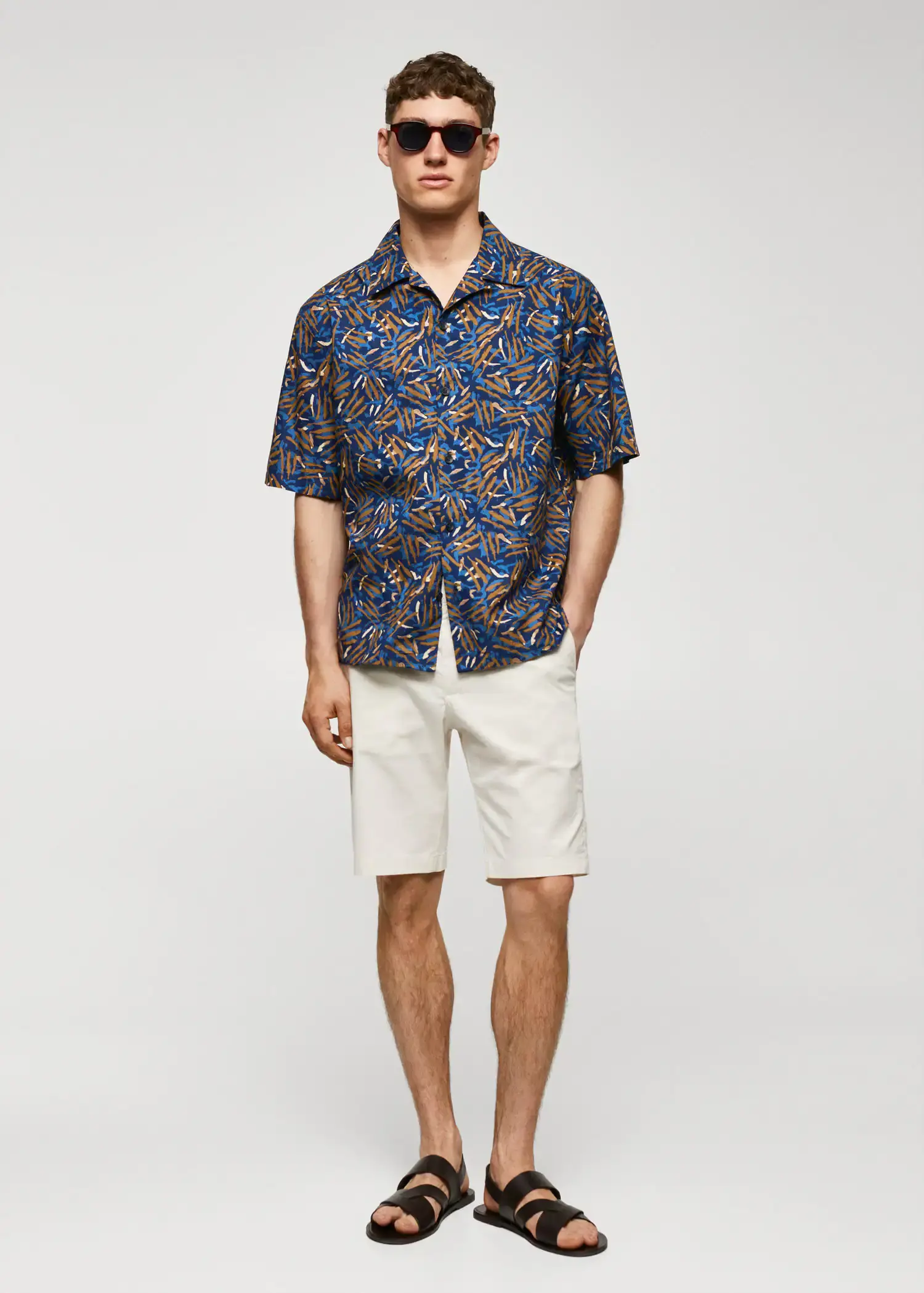 Mango 100% cotton bowling-collar shirt . a man in a blue and white shirt and white shorts. 