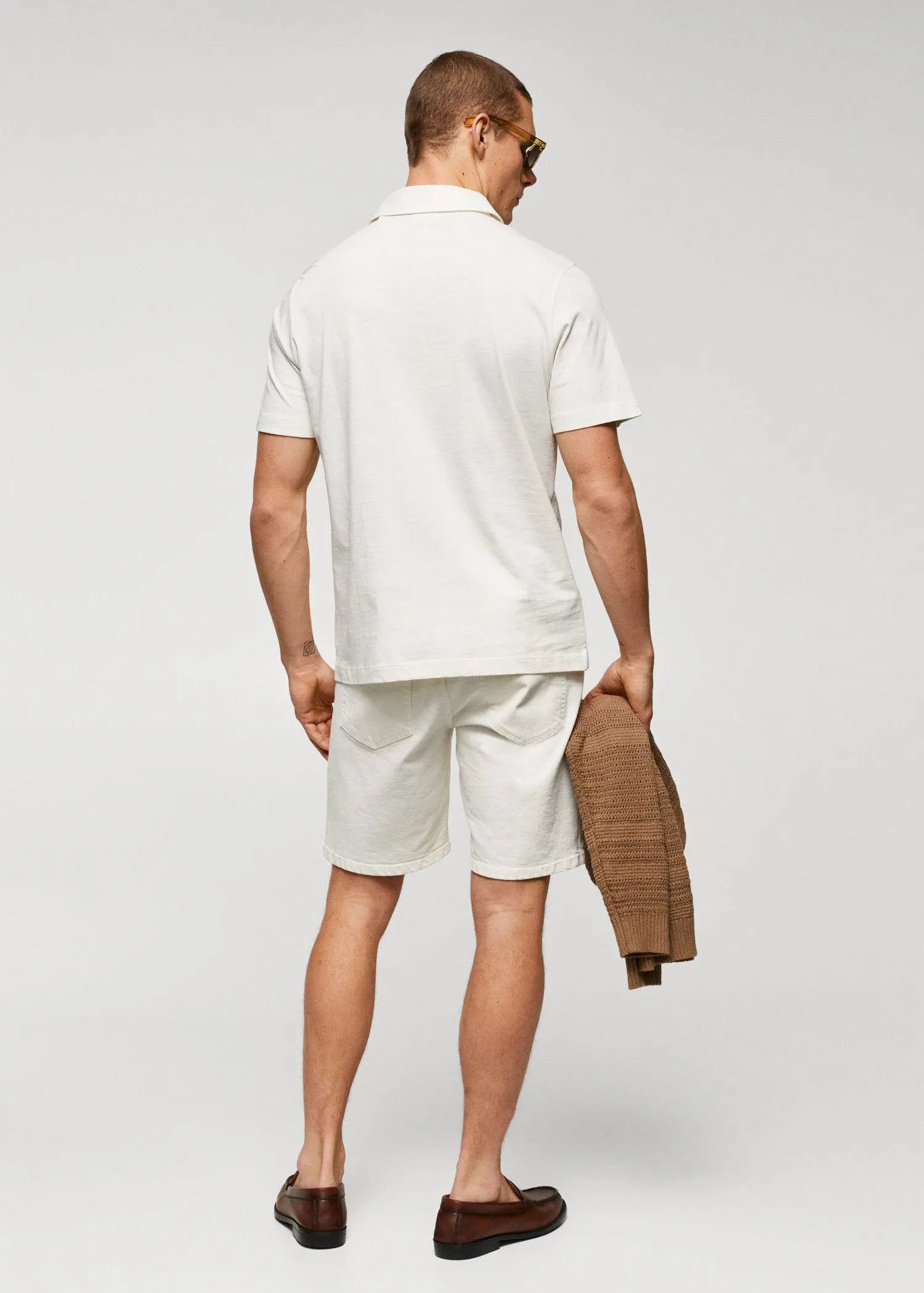 Mango 100% cotton basic polo shirt . a man in white shorts and a white polo shirt. 
