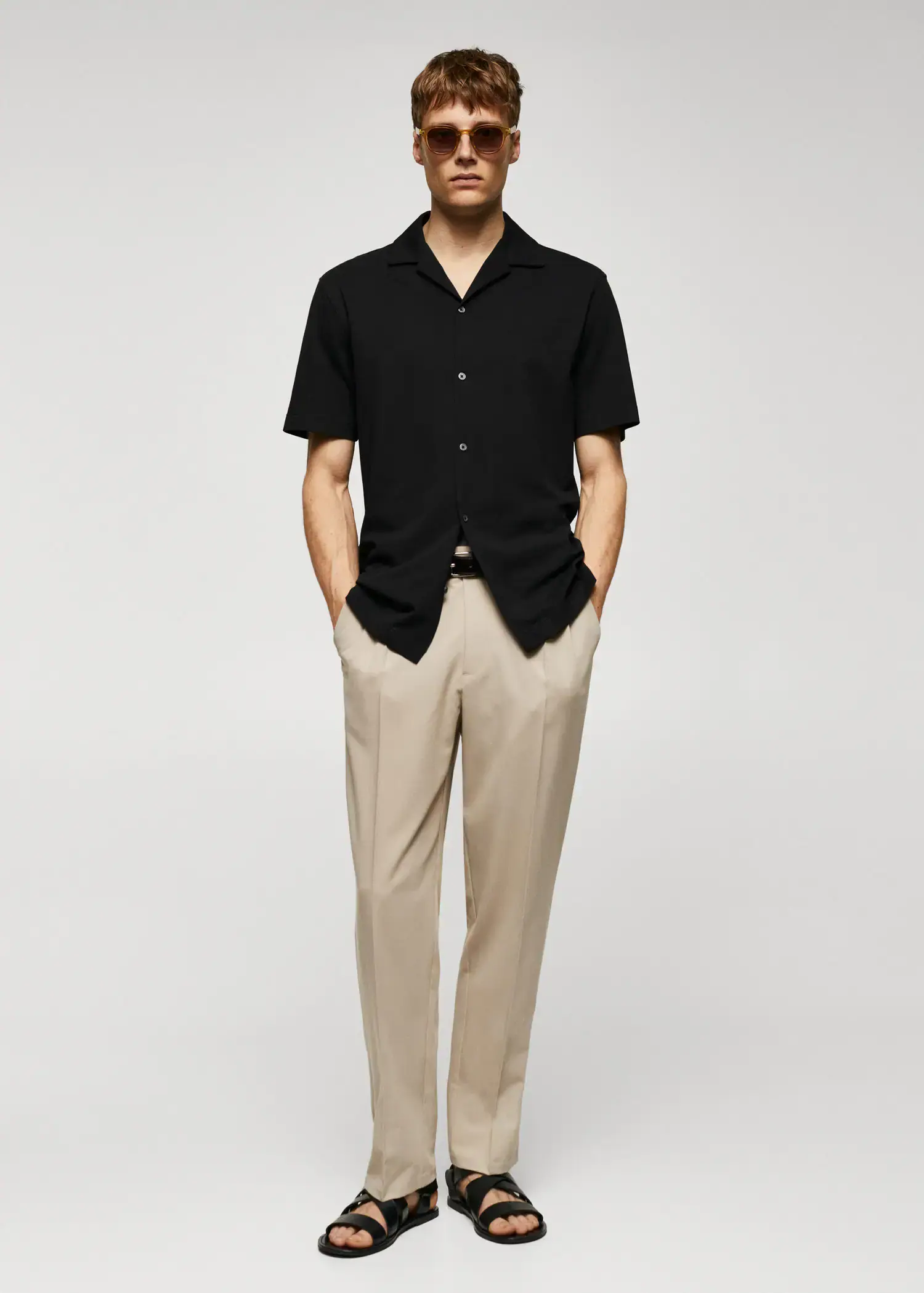 Mango Bowling-collar pique shirt. a man in a black shirt and beige pants. 