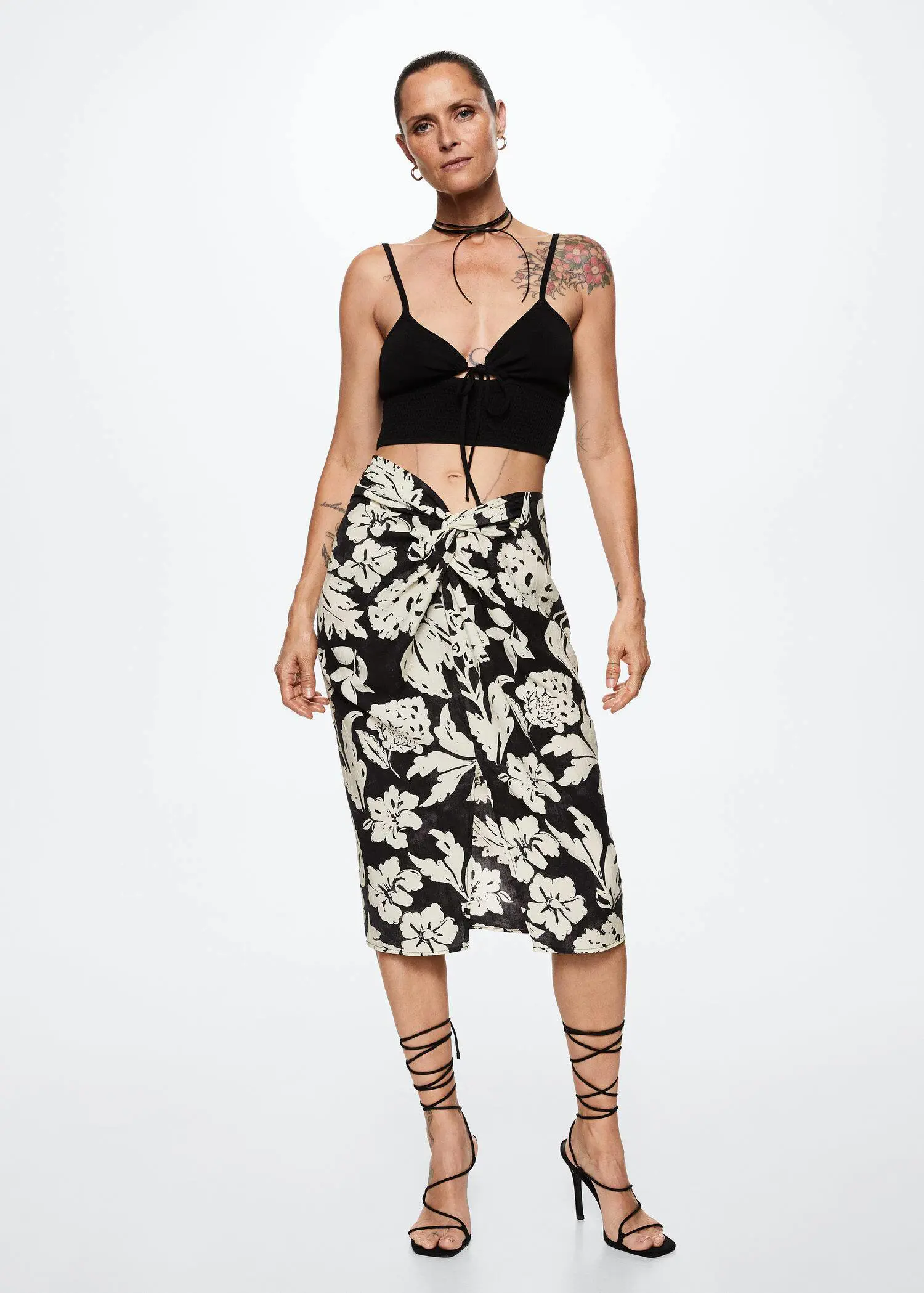 Mango Slit floral skirt. a woman in a black and white floral skirt. 