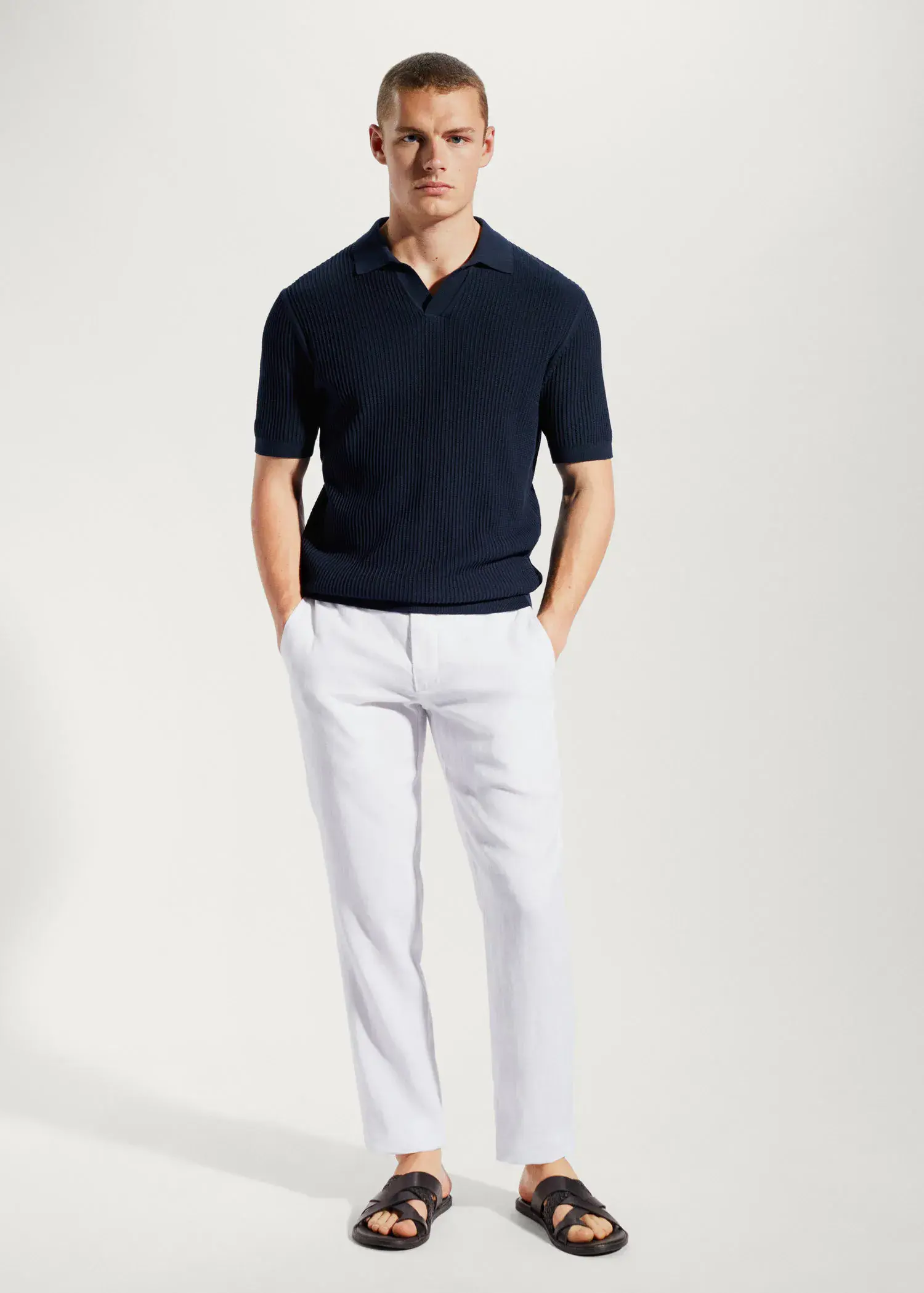 Mango Slim-fit 100% linen trousers. a man in a black shirt and white pants. 