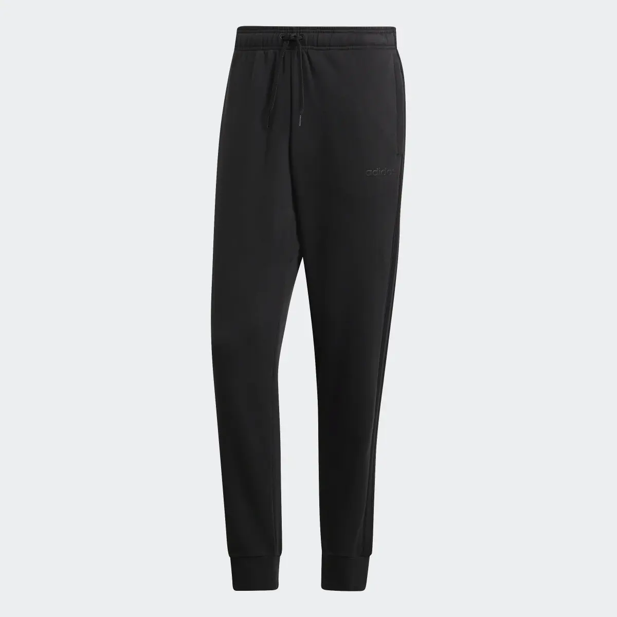 Adidas Pantalón Essentials Tapered Cuffed 3 bandas. 1