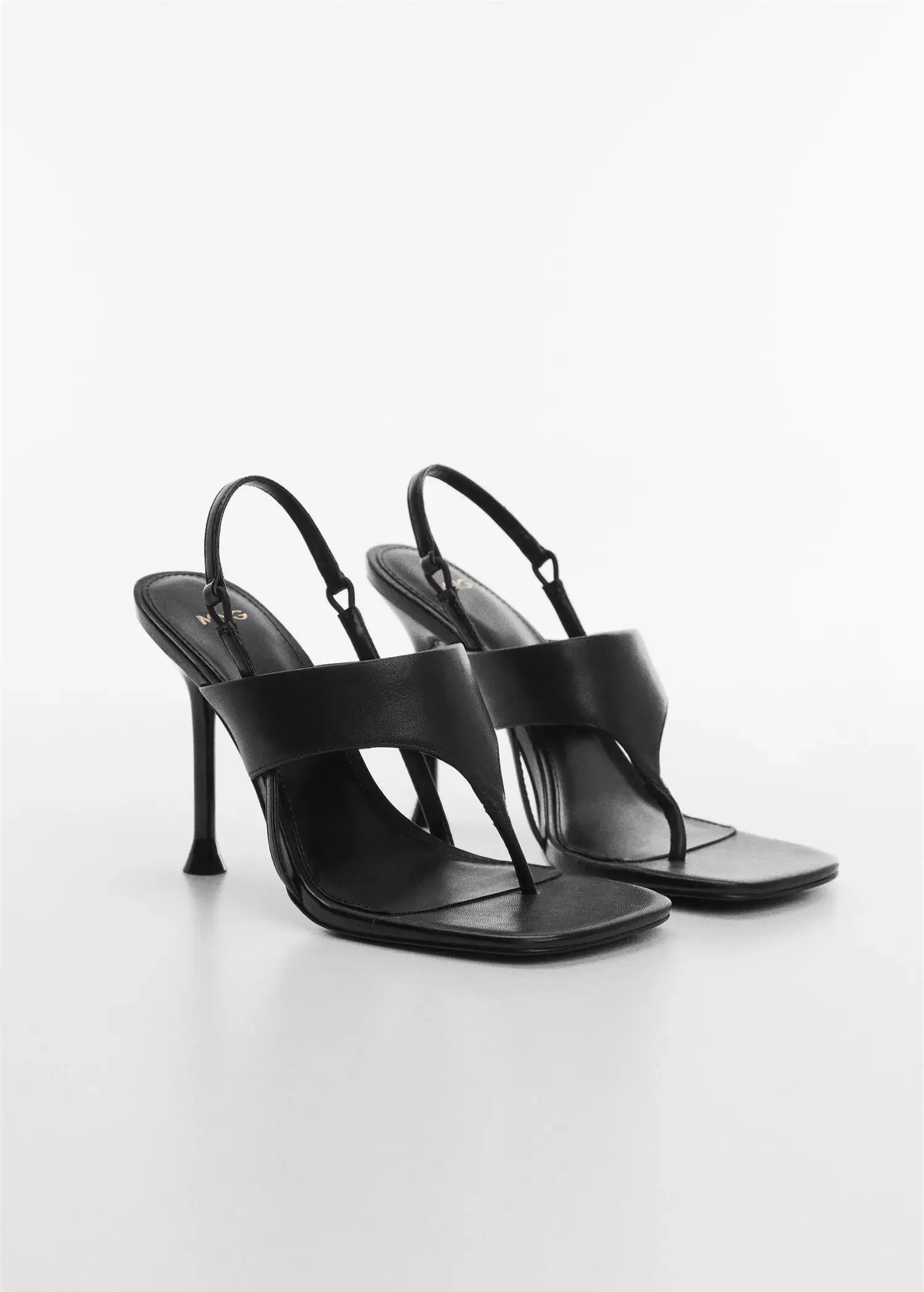 Mango Heeled leather sandals with straps. a pair of high heeled sandals on a white surface. 
