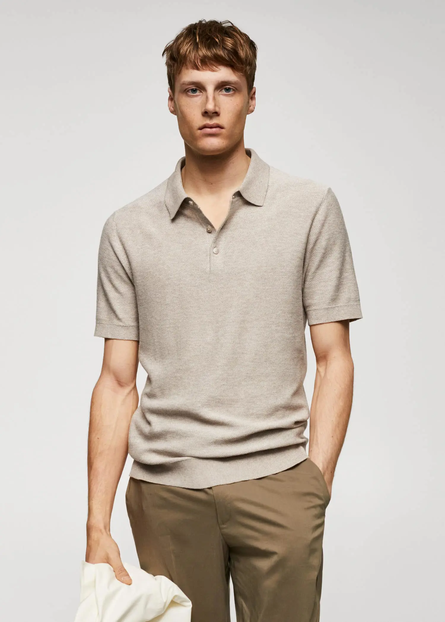Mango Patterned cotton polo shirt. a man in a beige polo shirt is posing for a picture. 