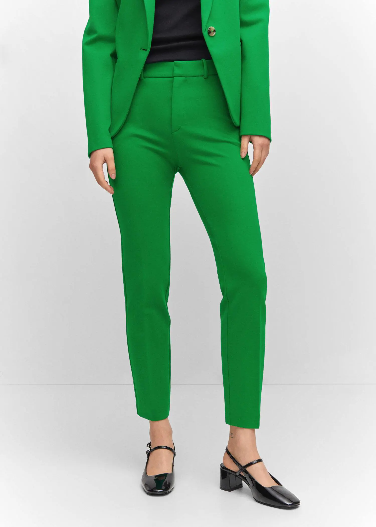 Mango Rome-knit straight pants. a person wearing a green suit and black shoes. 