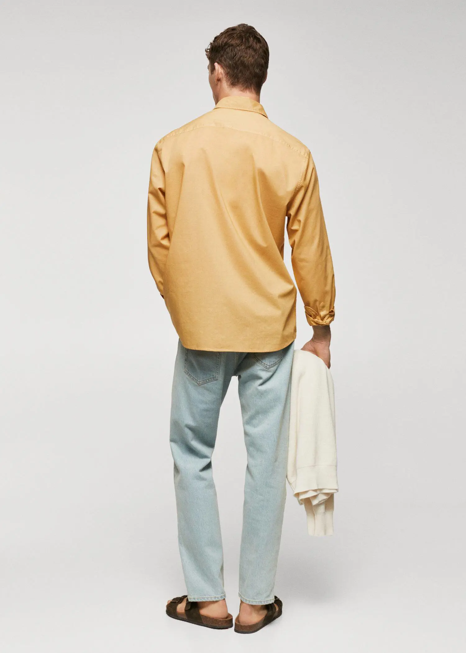 Mango Regular-fit cotton voile shirt. a man in a tan shirt is holding a towel. 