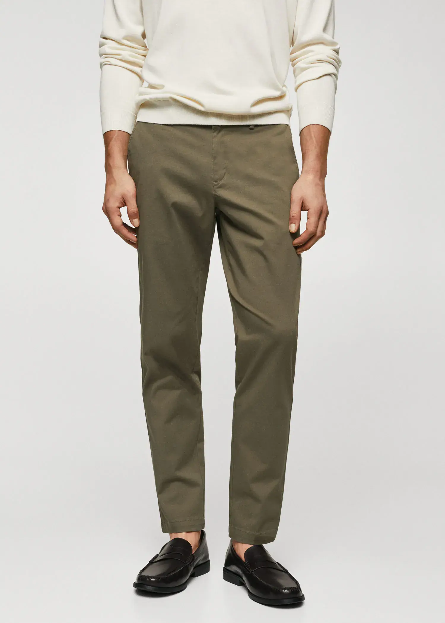 Mango Cotton tapered crop pants. a man wearing a white shirt and a pair of green pants. 