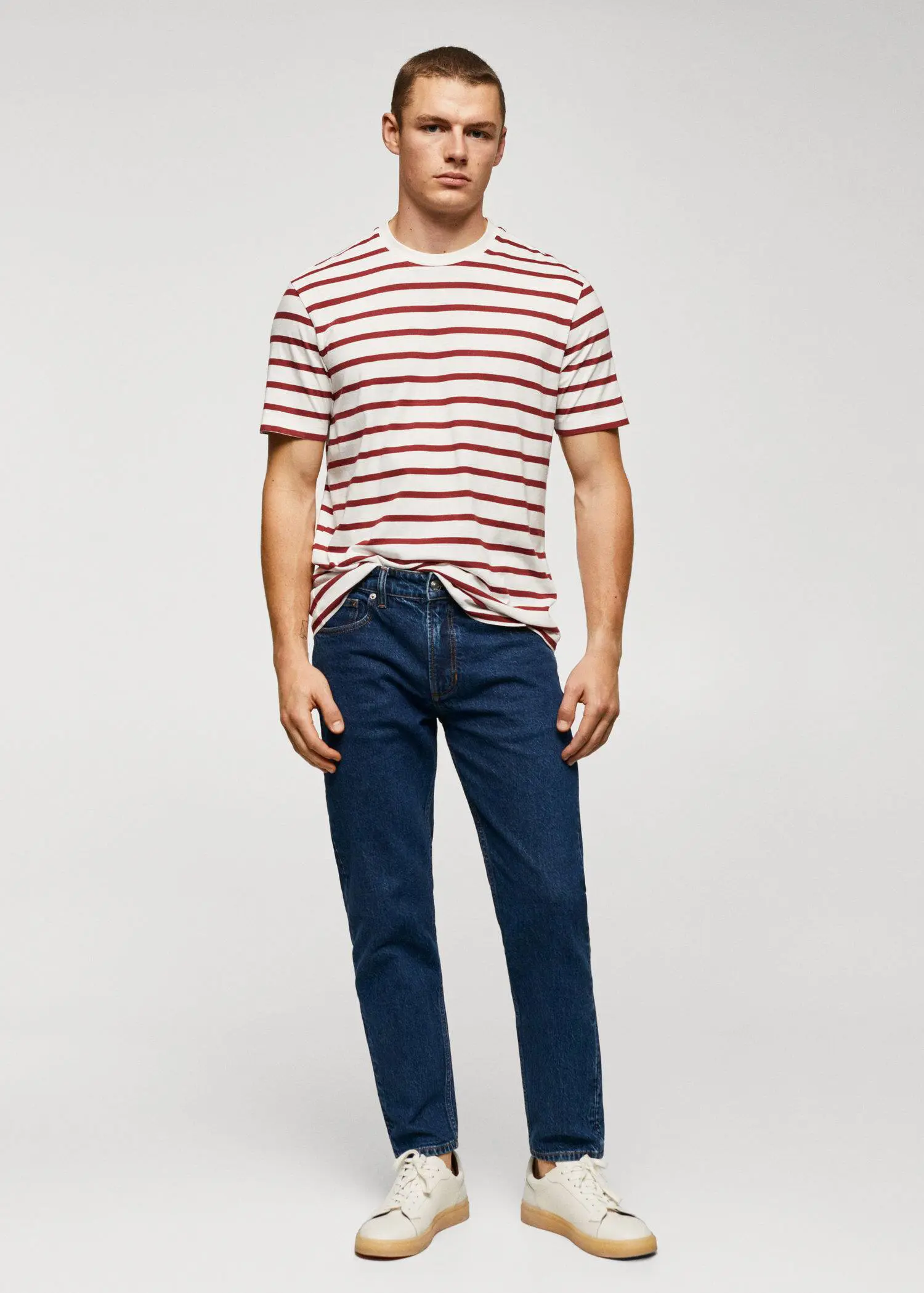 Mango Cotton-modal striped t-shirt. a man wearing a striped shirt and jeans. 