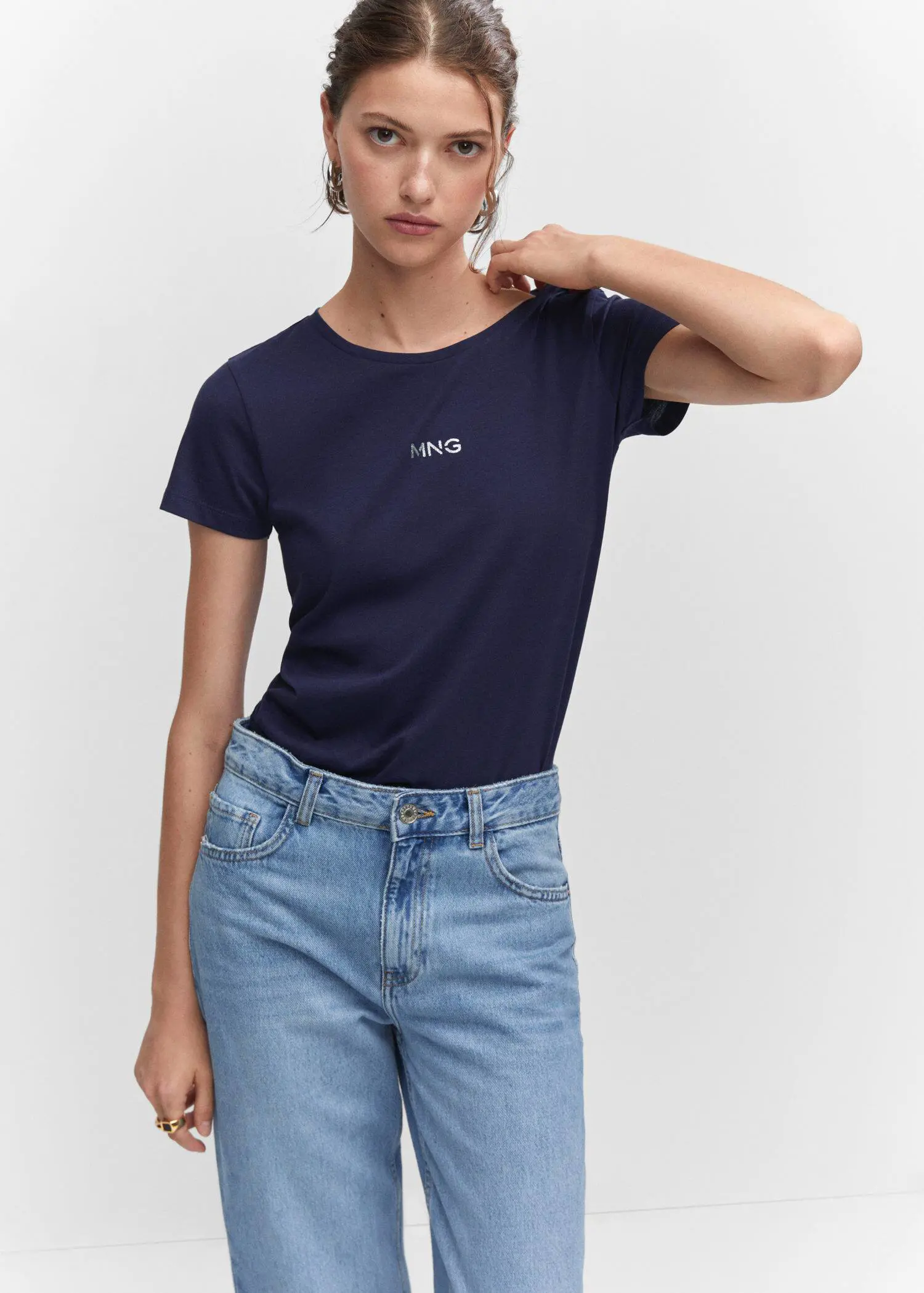 Mango Metallic logo T-shirt. a woman in blue jeans and a t-shirt 