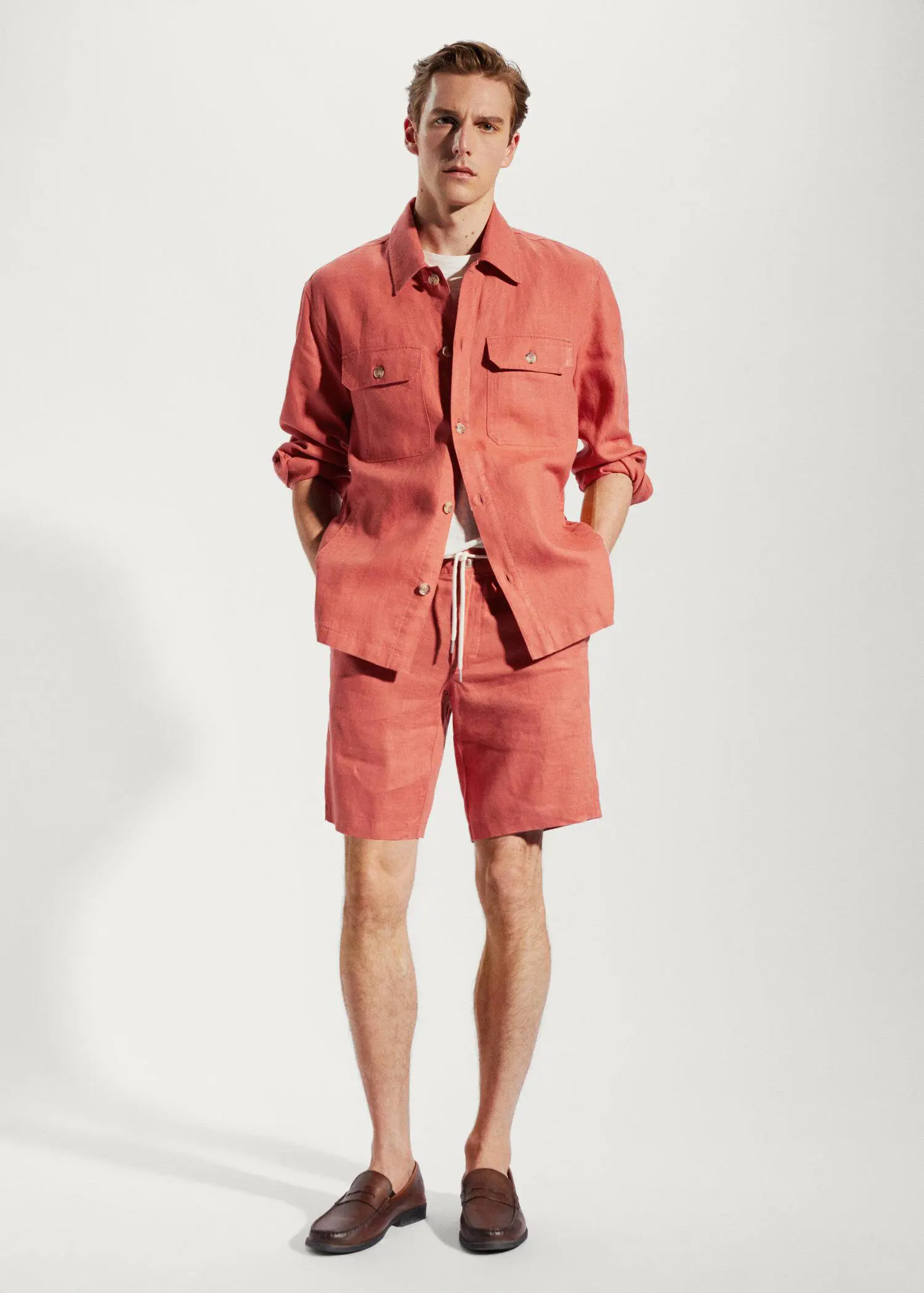 Mango 100% linen bermuda shorts with drawstring. a man wearing a red jacket and shorts. 