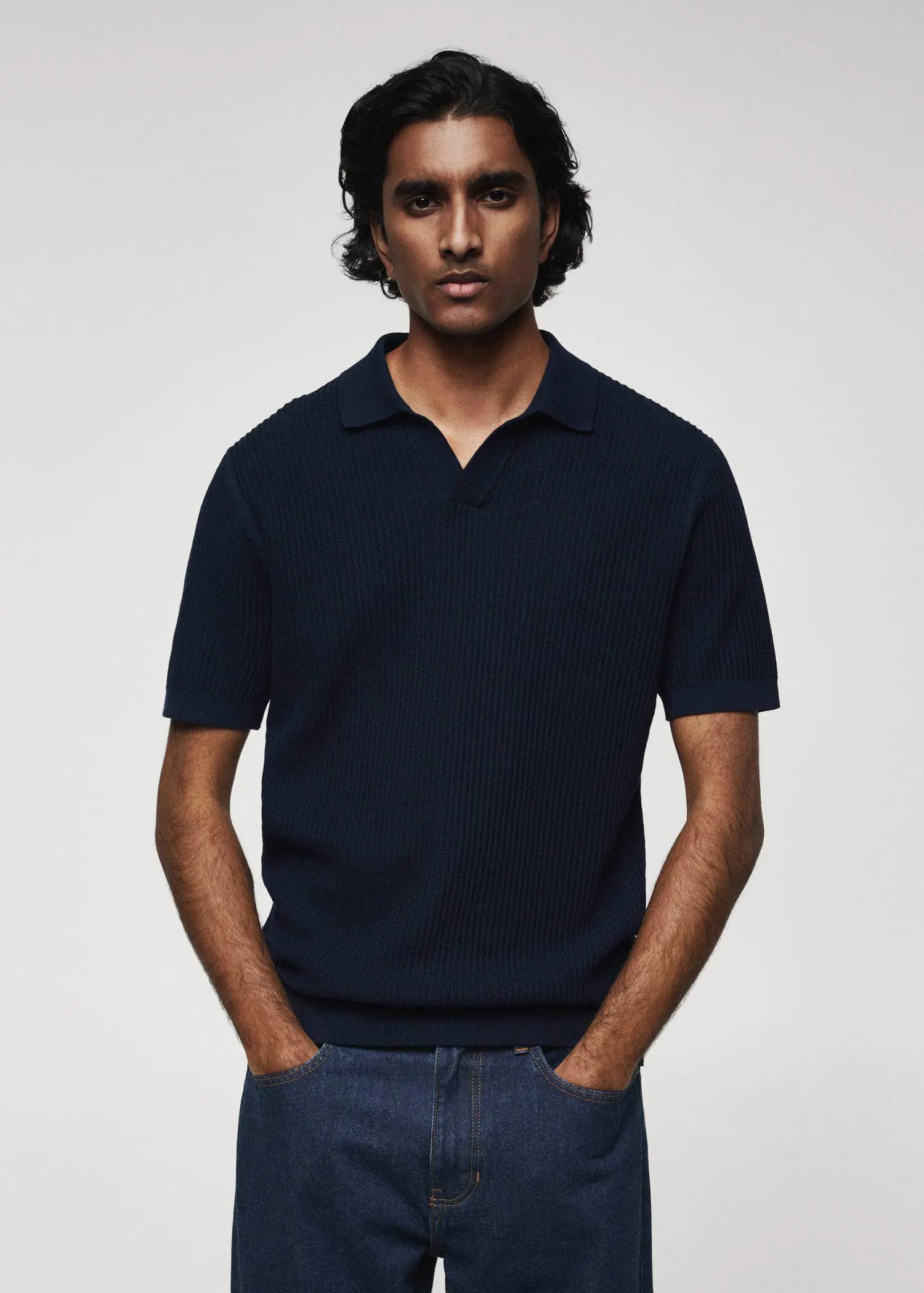 Mango Ribbed cotton polo shirt. a man wearing a polo shirt with his hands in his pockets 