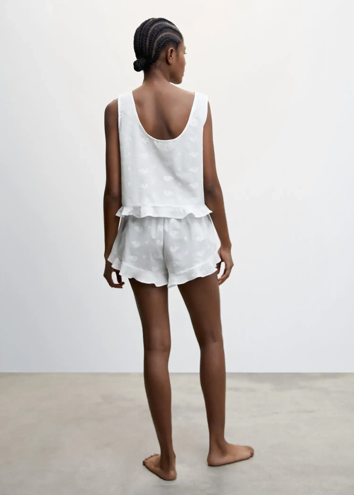 Mango Pajama shorts with openwork detail. a woman in white shorts and a white top. 