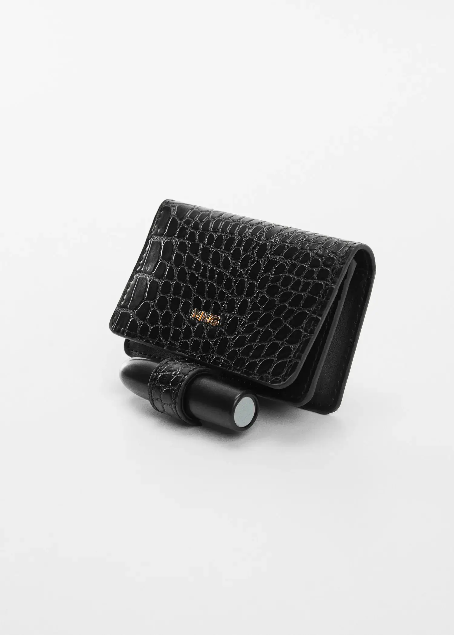 Mango Animal print effect wallet. a black purse and lipstick on top of a table. 
