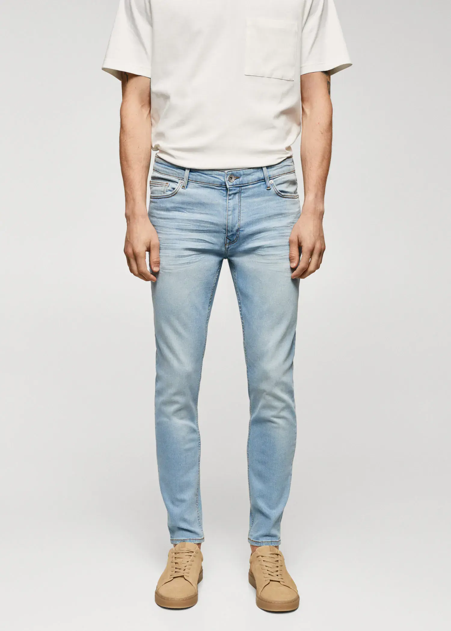 Mango Jude skinny-fit jeans. a man wearing light blue jeans and a white shirt. 