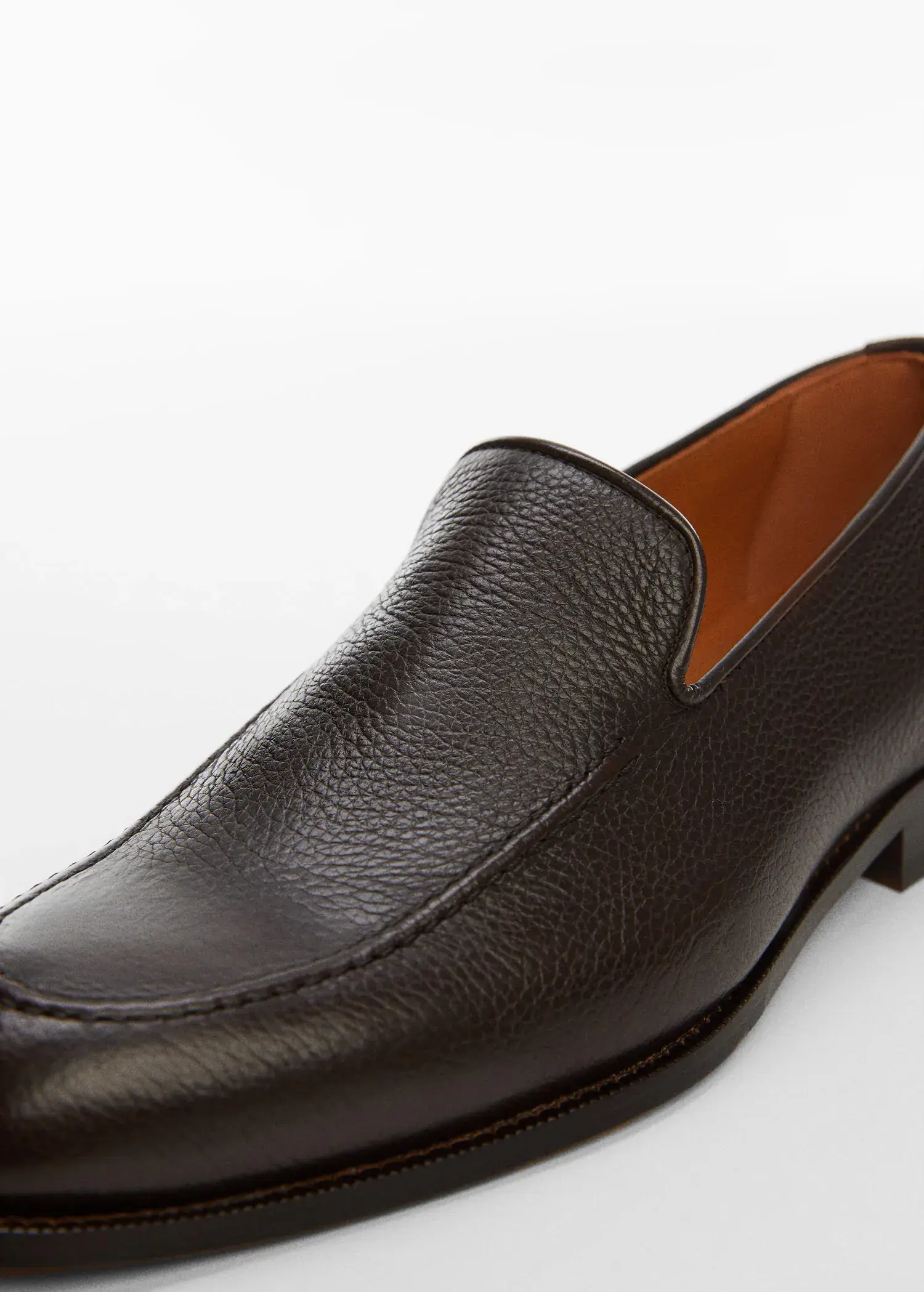 Mango Minimalist leather moccasins. a close-up of a brown loafer shoe. 
