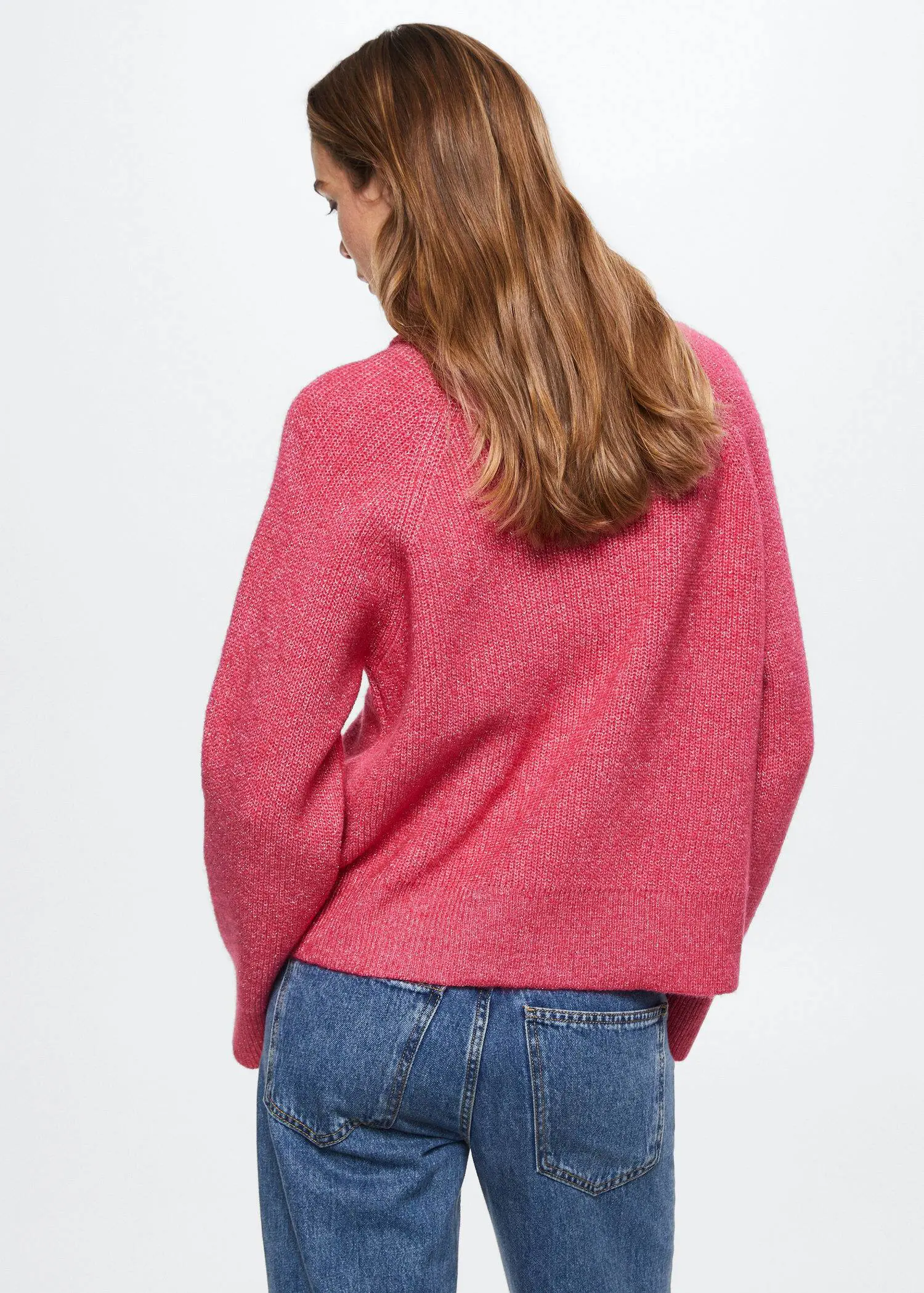 Mango Pullover lurex ribbed turtleneck. a woman wearing a pink sweater and blue jeans. 