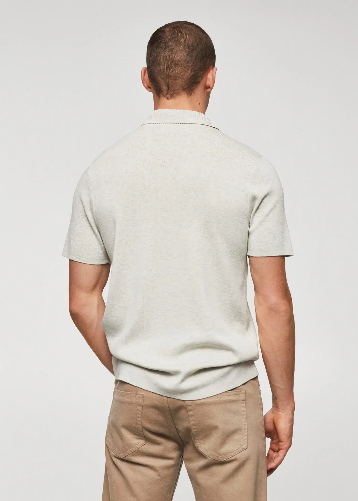 Mango Fine-knit polo shirt. a man in a white shirt and brown pants. 