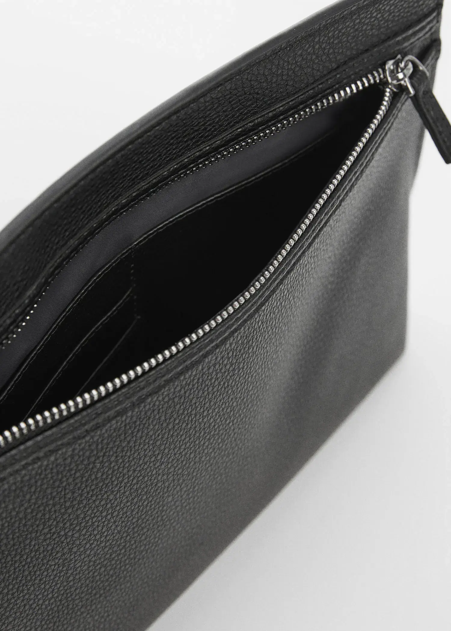 Mango Leather-effect case. a close-up view of the inside of a black purse. 